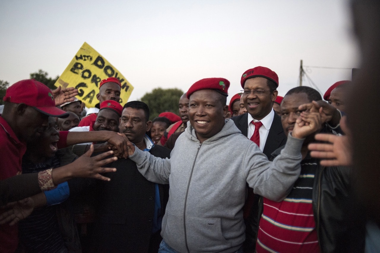 South African opposition party Economic Freedom Fighters (EFF) leader Julius Malema (C) arrives to give a speech in Alexandra Township, as part of an anti-foreigner violence campaign in Johannesburg, 20 April 2015, STEFAN HEUNIS/AFP/Getty Images