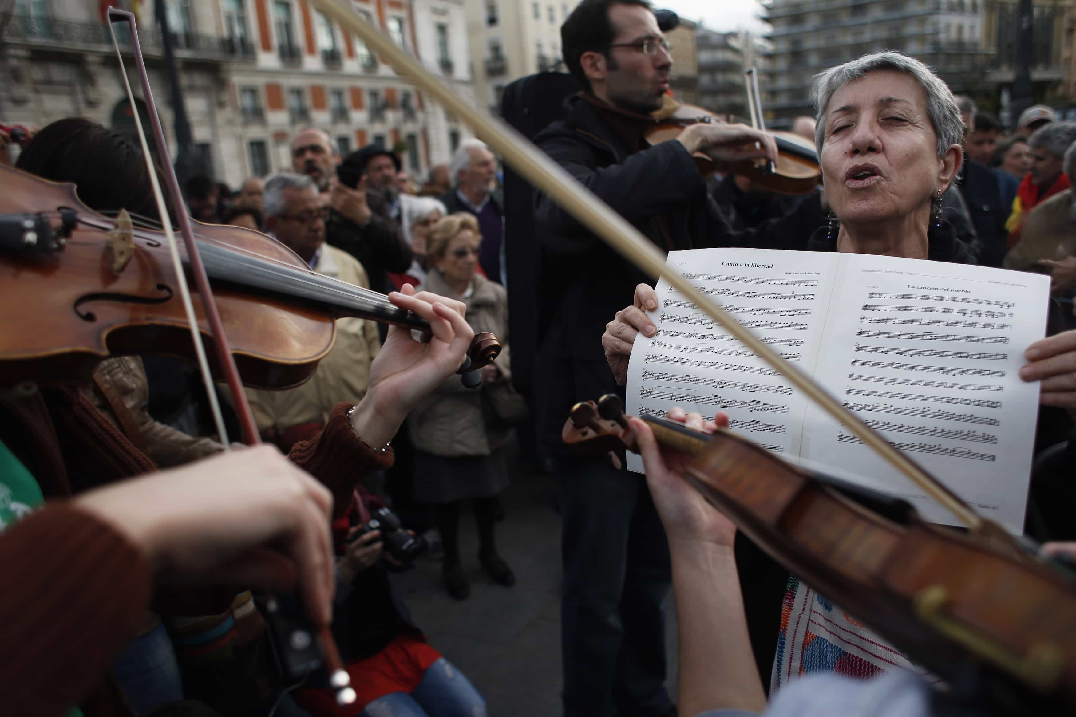 Demonstrators play music during a gathering to mark the second anniversary of the 15M movement at Madrid's landmark Puerta del Sol Square May 15, 2013, REUTERS/Susana Vera