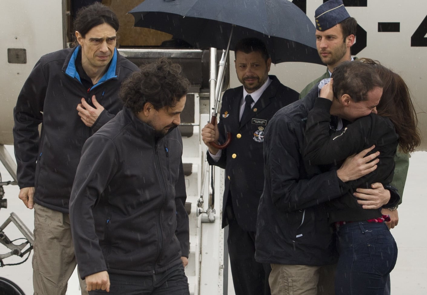 On 8 May 2016, the three freed Spanish journalists Antonio Pampliega, right, Jose Manuel Lopez, left, and Angel Sastre, arrive at the Torrejon military airbase in Madrid, Spain, Pool Moncloa via AP