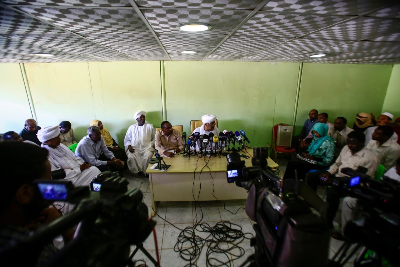 Idris Suleiman (C), political secretary of the Popular Congress Party, speaks during a press conference at the party's headquarters in Khartoum, Sudan, 26 December 2018; the party has called for a probe in the killings of protesters, ASHRAF SHAZLY/AFP/Getty Images