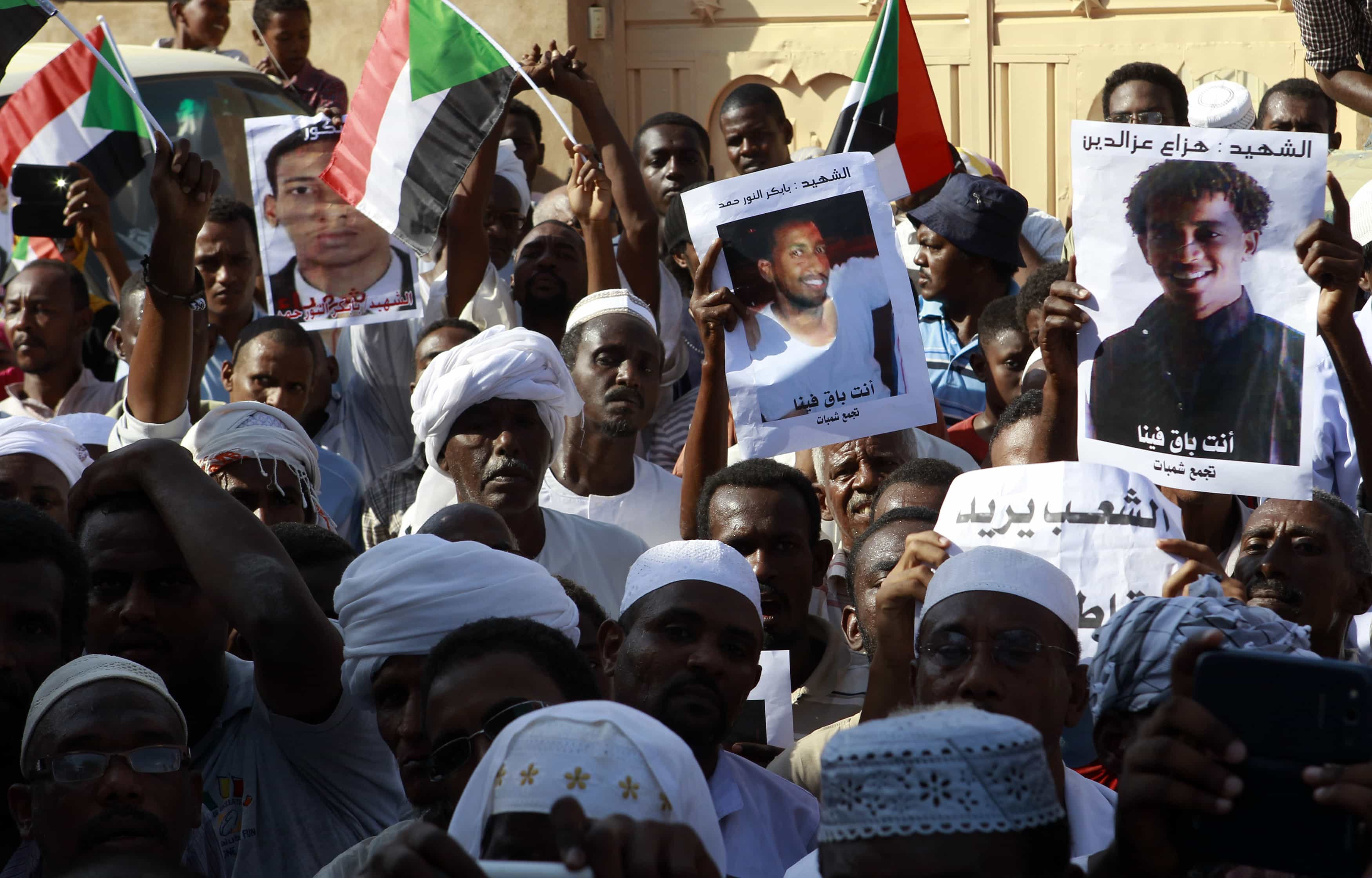 People carry pictures depicting whom they say are victims of the government's deadly crackdown on protesters, in north Khartoum, 4 October 2013., REUTERS/Stringer