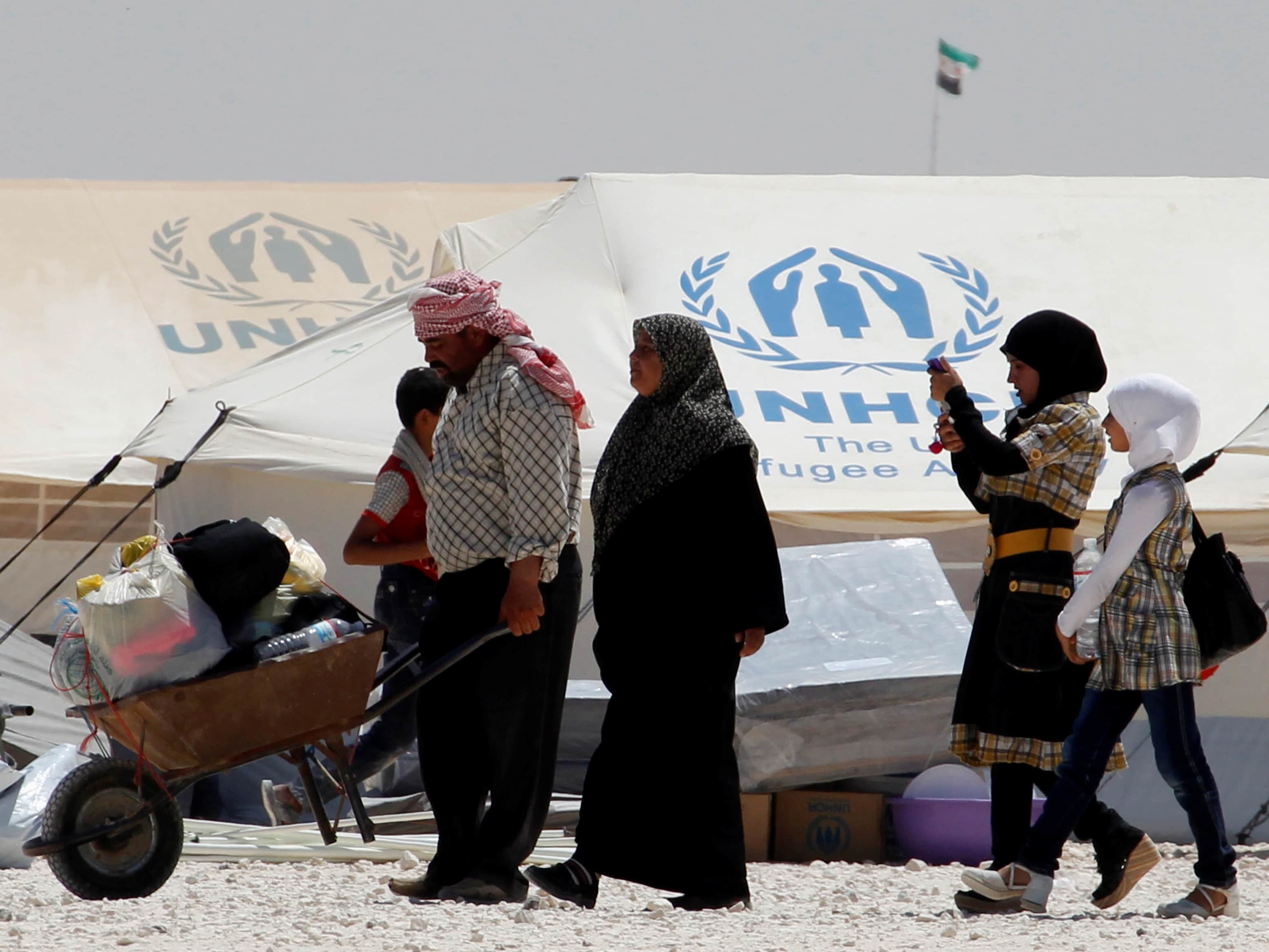 A newly arrived Syrian refugee receives aid and rations, at Al-Zaatri refugee camp in the Jordanian city of Mafraq, near the border with Syria, on World Refugee Day, 20 June 2013, REUTERS/Muhammad Hamed