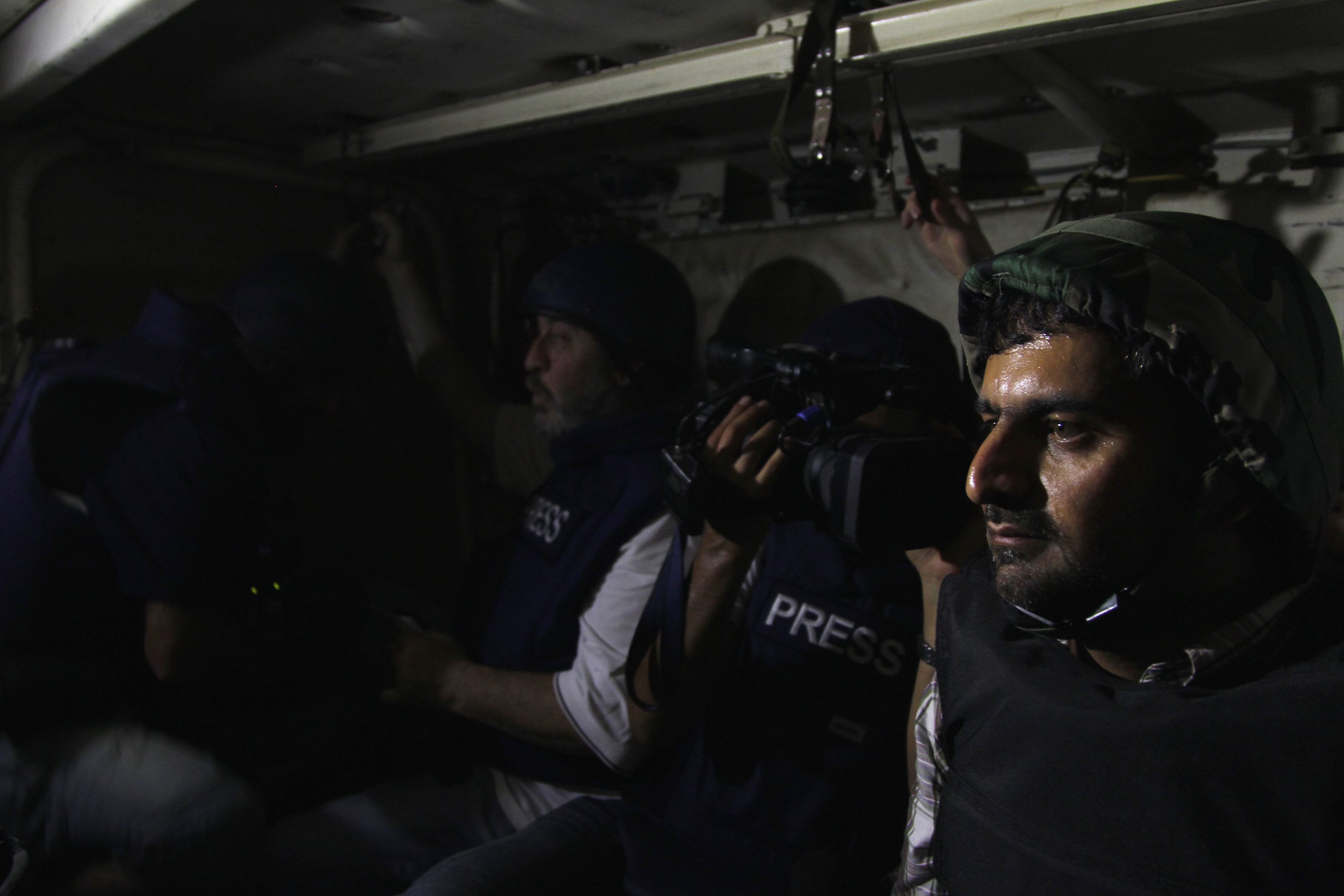 Journalists sit in an army soldier's carrier on their way to the front line, during clashes between forces loyal to Syria's President and opposition fighters on 24 August 2013, REUTERS/Khaled al-Hariri