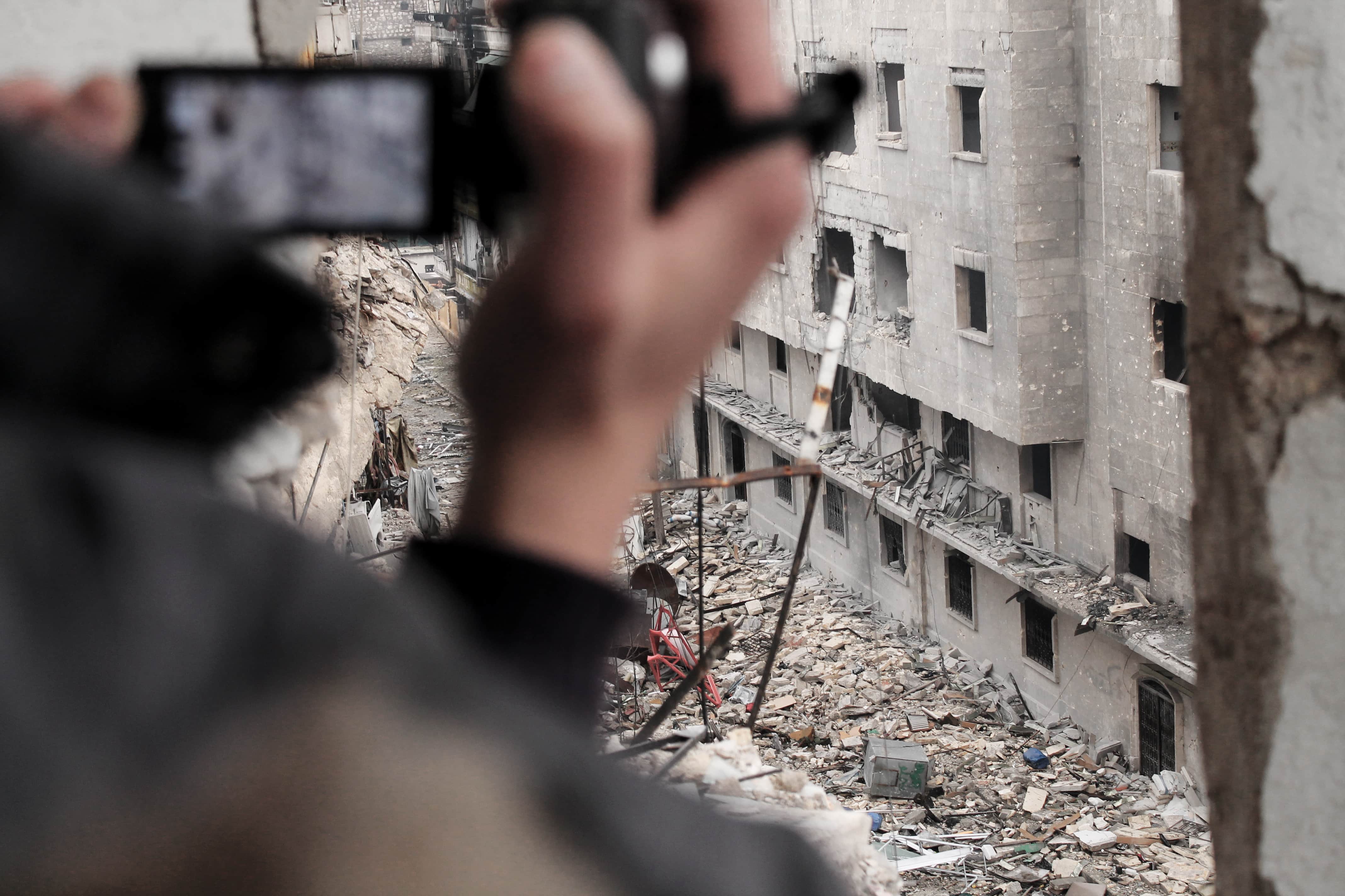 Media activist filming Free Army fighters near the regime's army in Aleppo, Syria, December 2012, Halabi Lens/Demotix