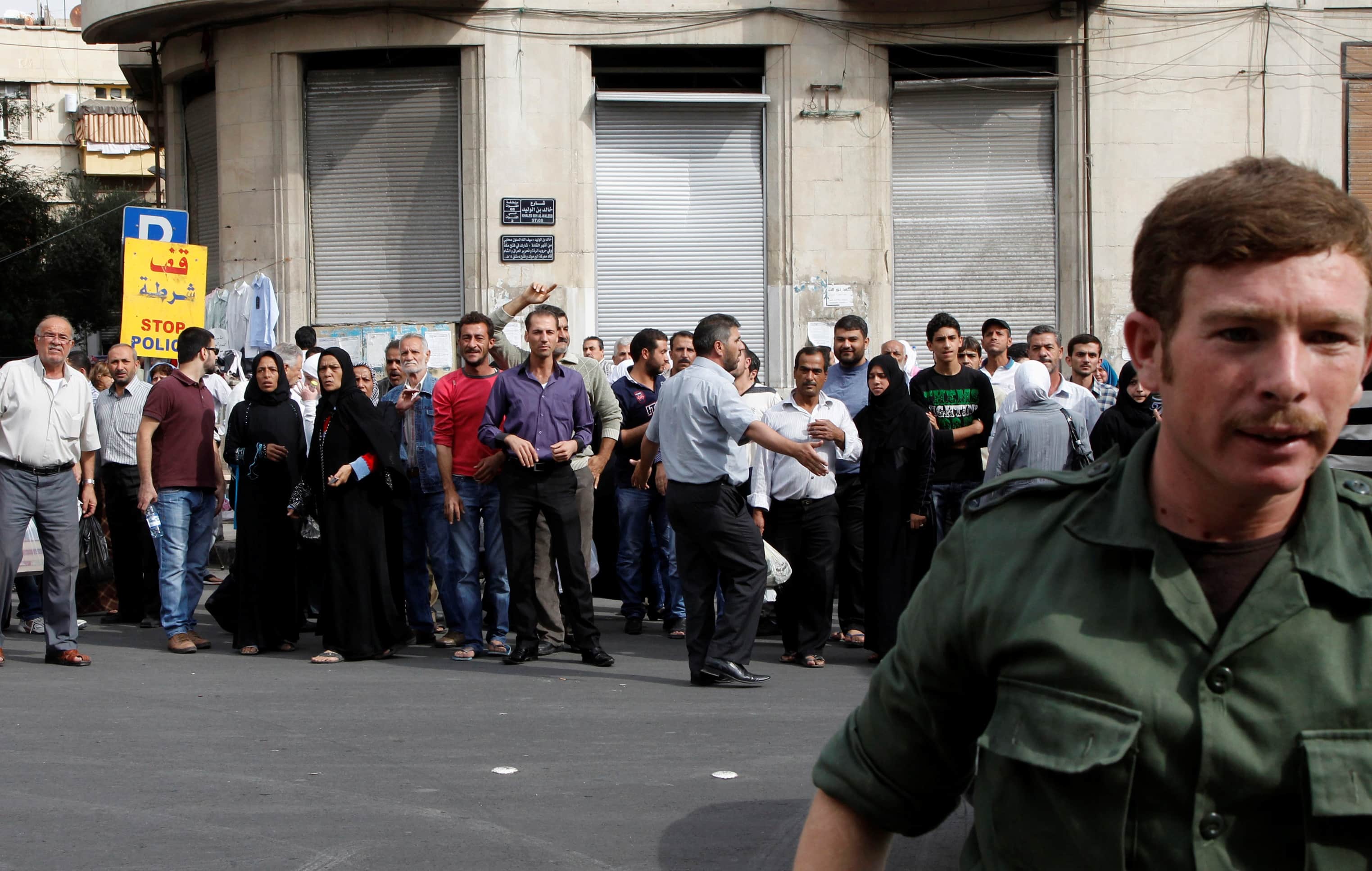 Relatives of Syrian detainees who were arrested over participation in protests against Syrian President Bashar al-Assad's regime, wait in front of a police building in Damascus  on 24 October 2012, REUTERS/Khaled al- Hariri