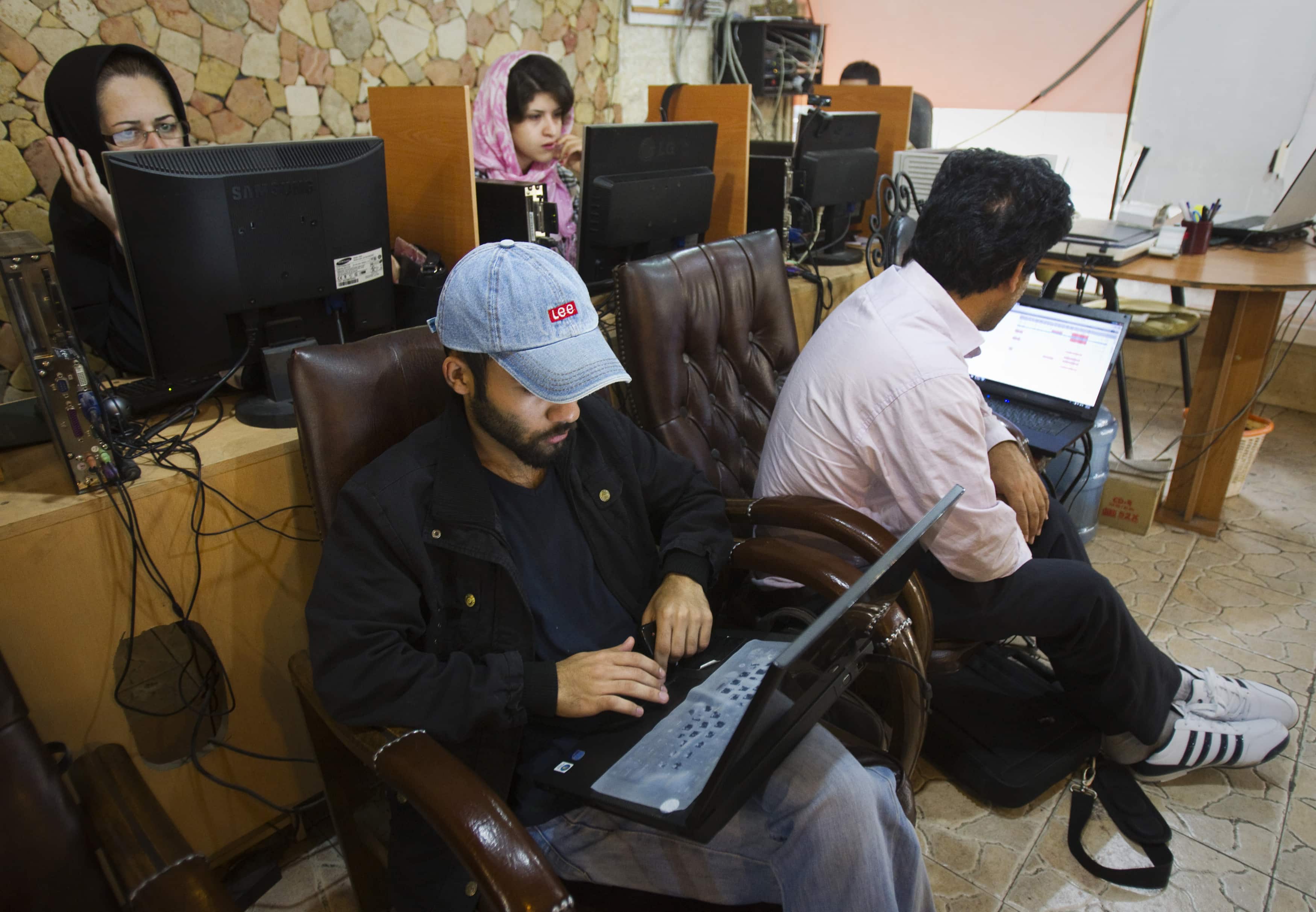 Customers use computers at an internet cafe in Tehran May 9, 2011, REUTERS/Raheb Homavandi