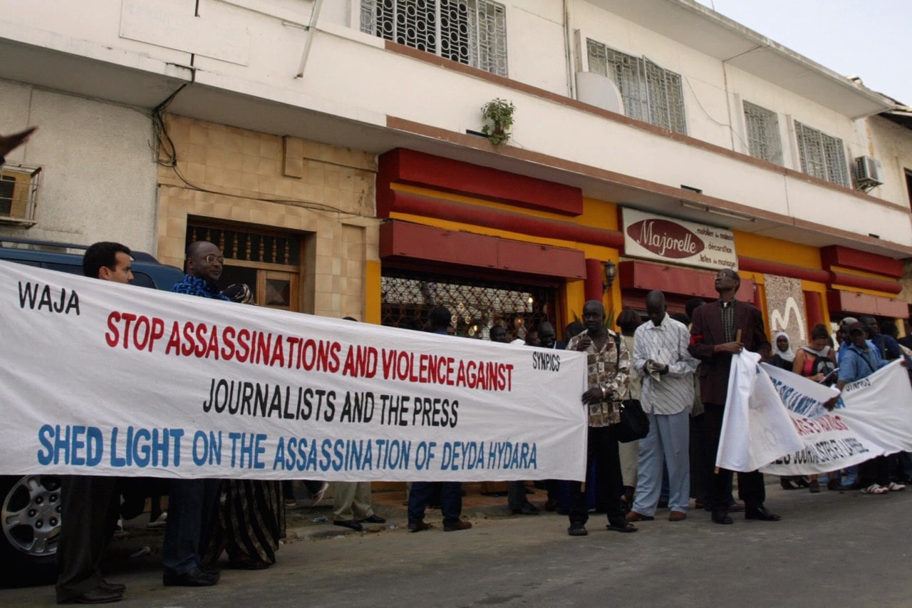 People call for an investigation into the murder of journalist Deida Hydara during a protest in front of Gambia's high commission in Dakar, Senegal, 22 December 2004, SEYLLOU/AFP/Getty Images
