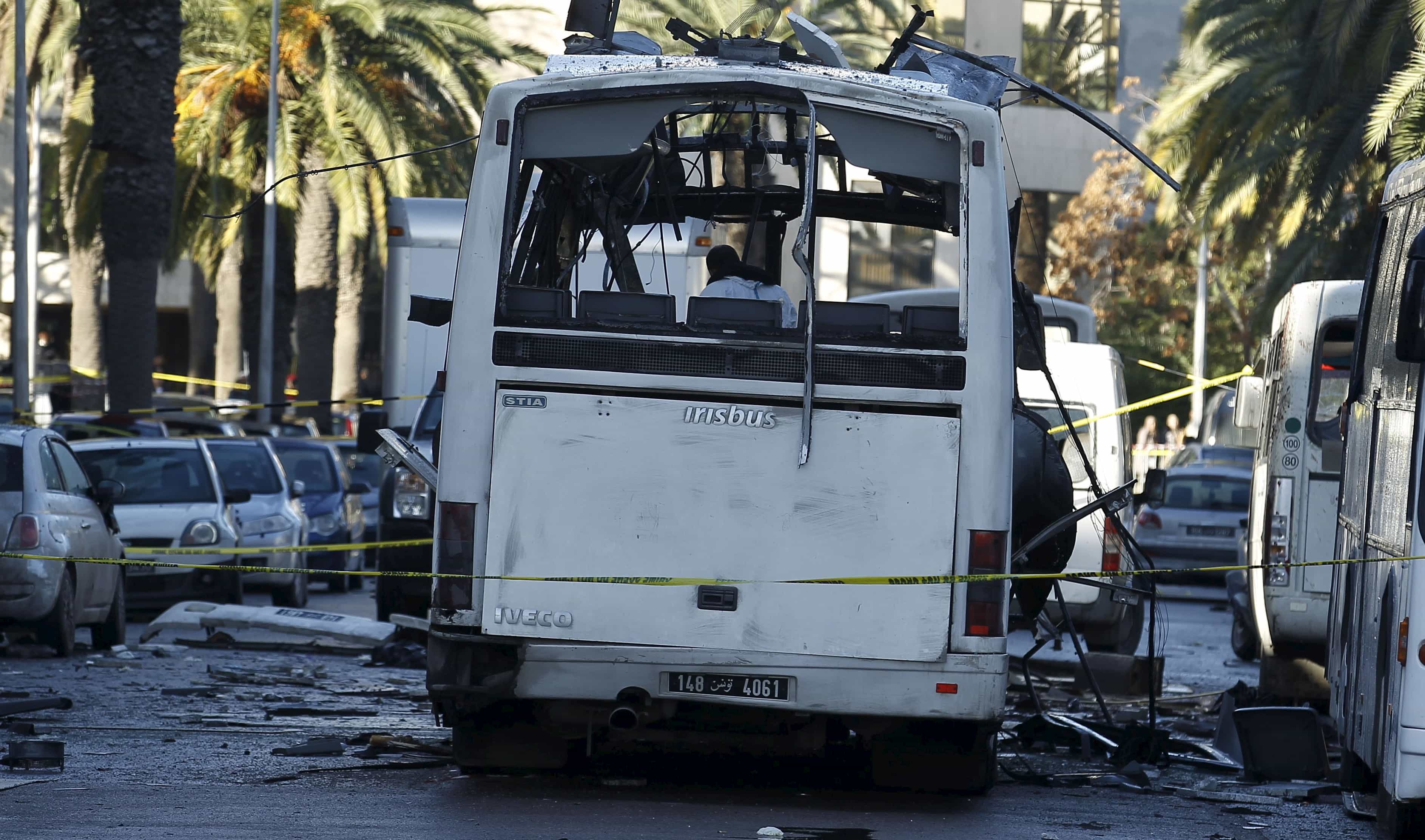 Tunisian forensics police inspect a Tunisian presidential guard bus at the scene of a suicide bomb attack in Tunis, Tunisia November 25, 2015, REUTERS/Zoubeir Souissi