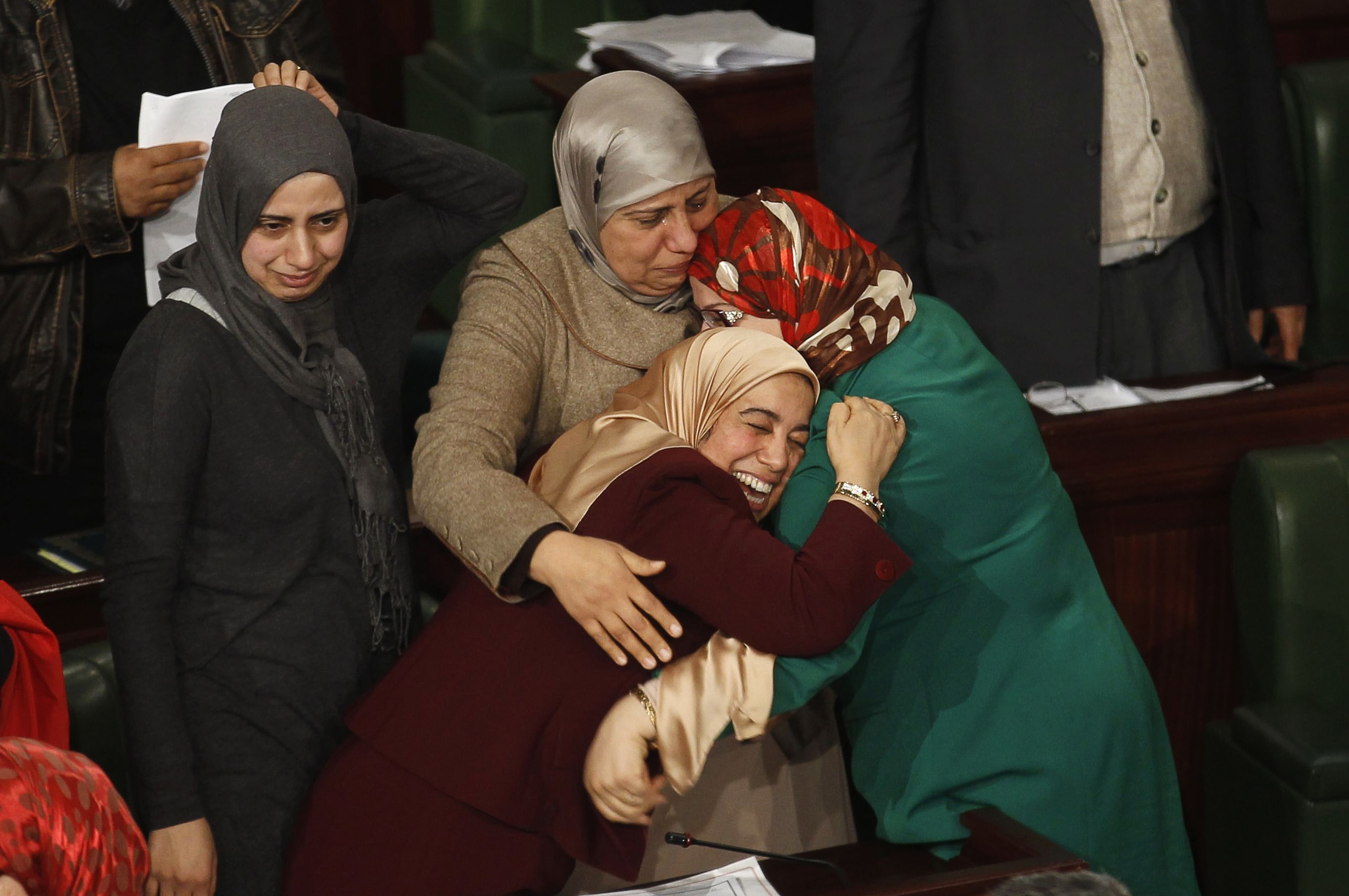 Members of the Tunisian parliament celebrate after approving the country's new constitution in the assembly building in Tunis, REUTERS/Zoubeir Souissi