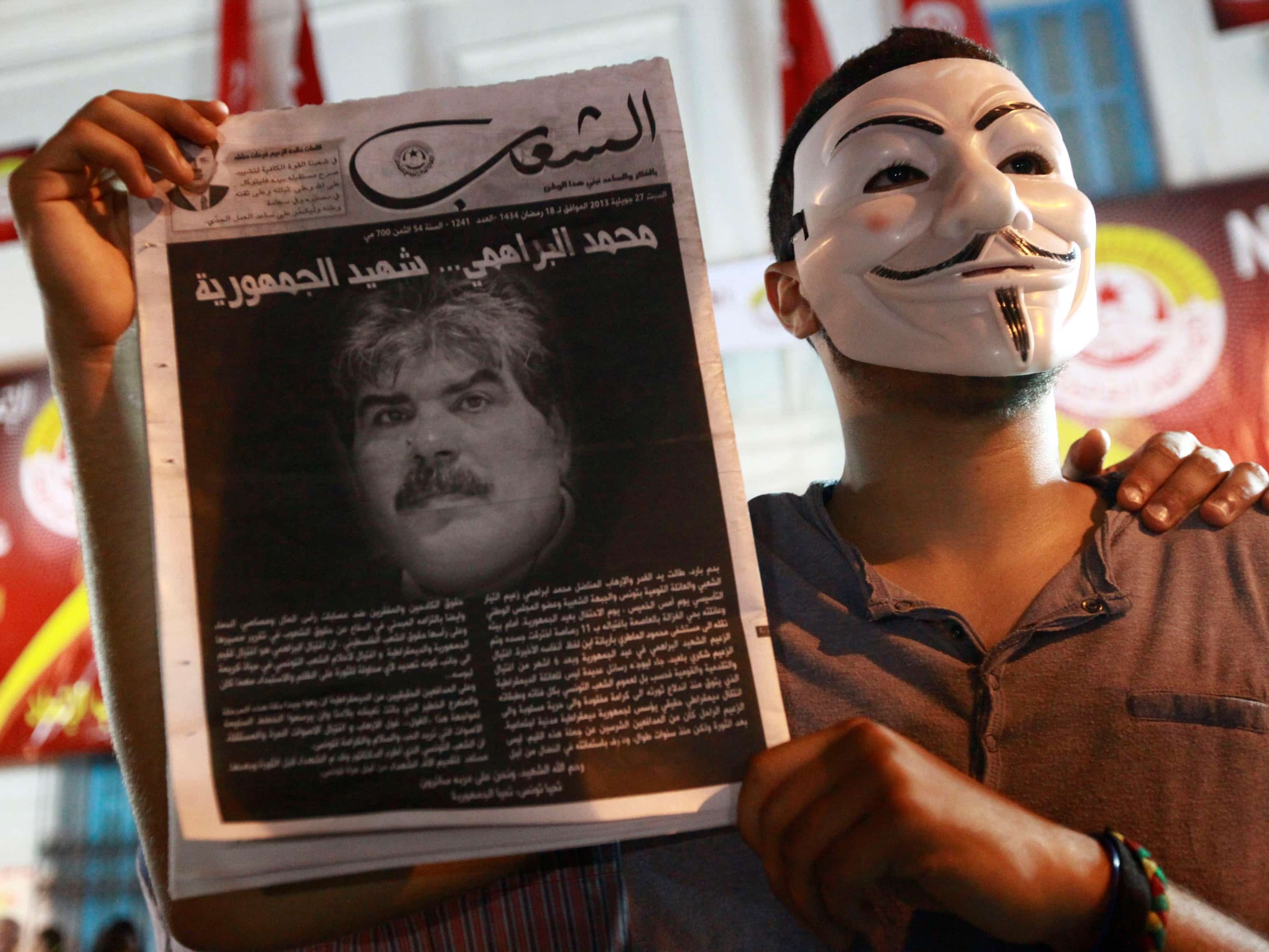 A demonstrator holds up a poster with an image of slain opposition figure Mohamed Brahimi to protest his assassination in Tunis on 25 July 2013, REUTERS/Anis Mili