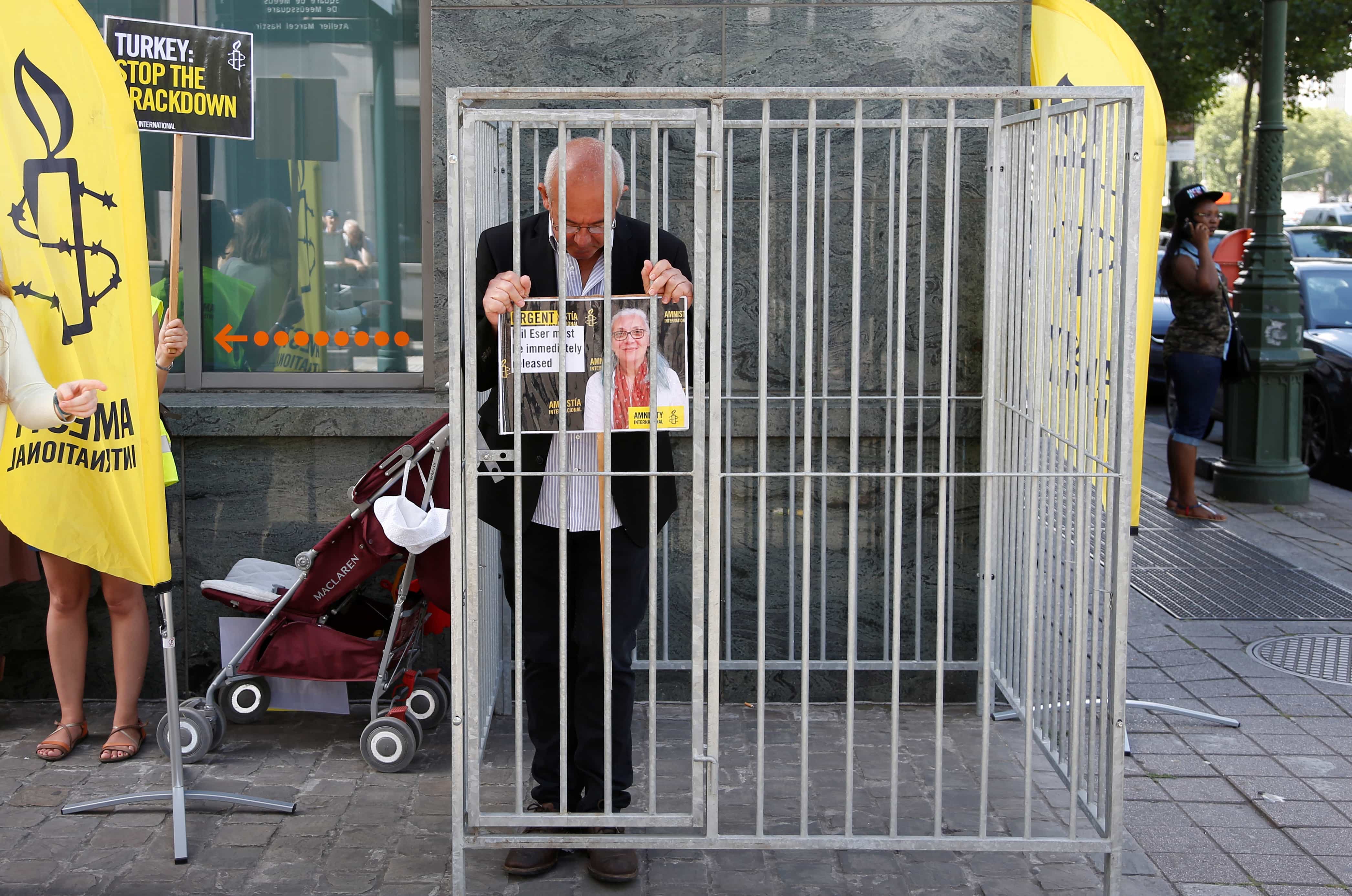 Amnesty International Belgium's Director Philippe Hensmans poses in a cage in front of the Turkish embassy in Brussels on 10 July 2017 to protest against the detention of his Turkish counterpart Idil Eser, REUTERS/Francois Lenoir