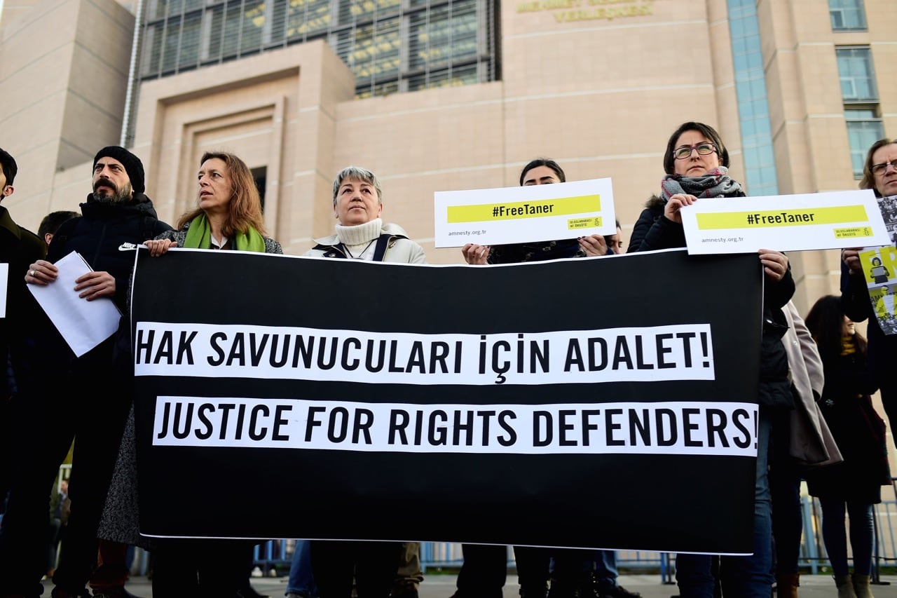 A group of activists gather outside the Caglayan courthouse in Istanbul, Turkey on 31 January 2018, calling for the release of Taner Kılıç as the trial of eleven human rights activists resumed, YASIN AKGUL/AFP/Getty Images
