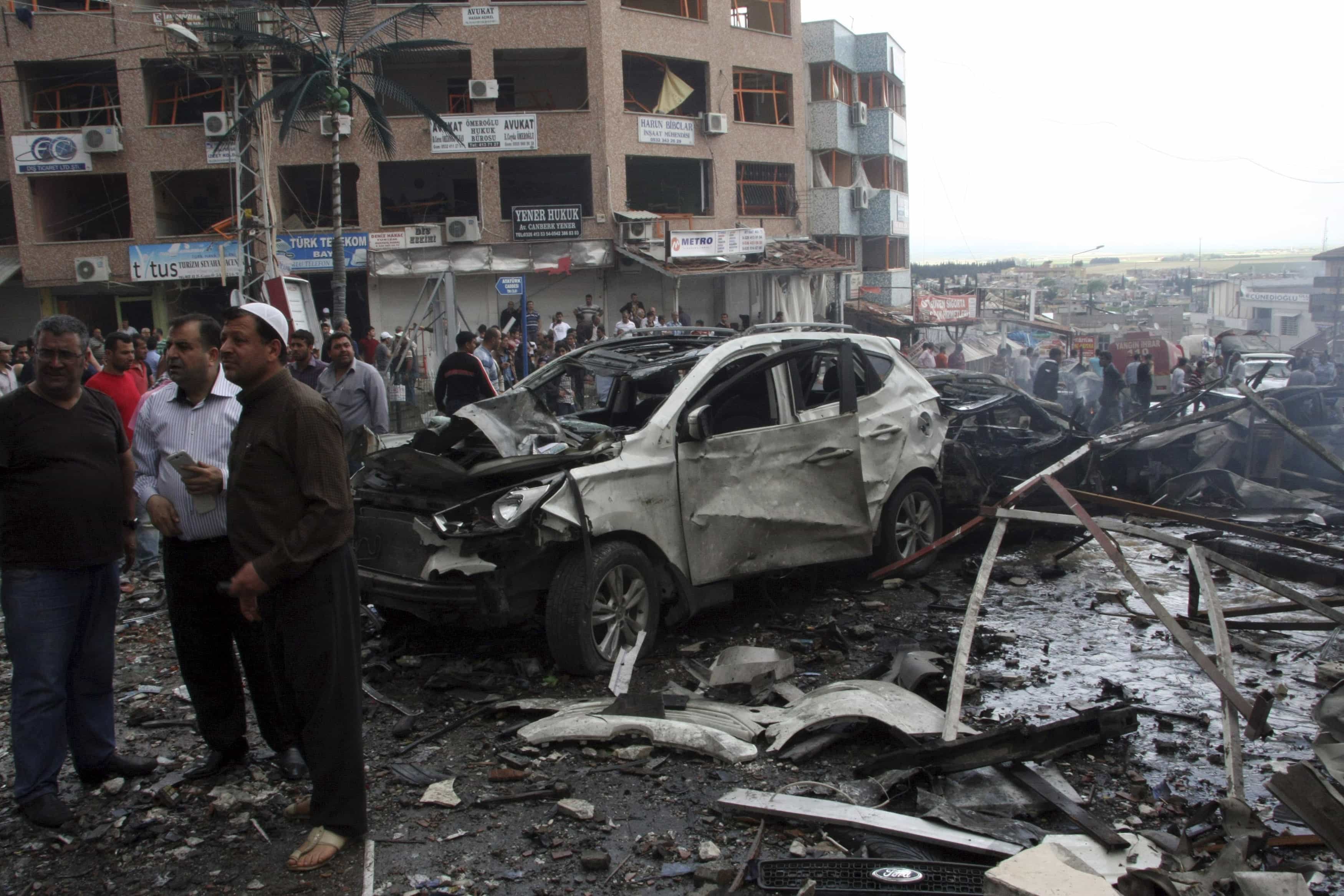 People gather at the site of an explosion in the town of Reyhanli near the Turkish-Syrian border on 11 May 11 2013., Reuters