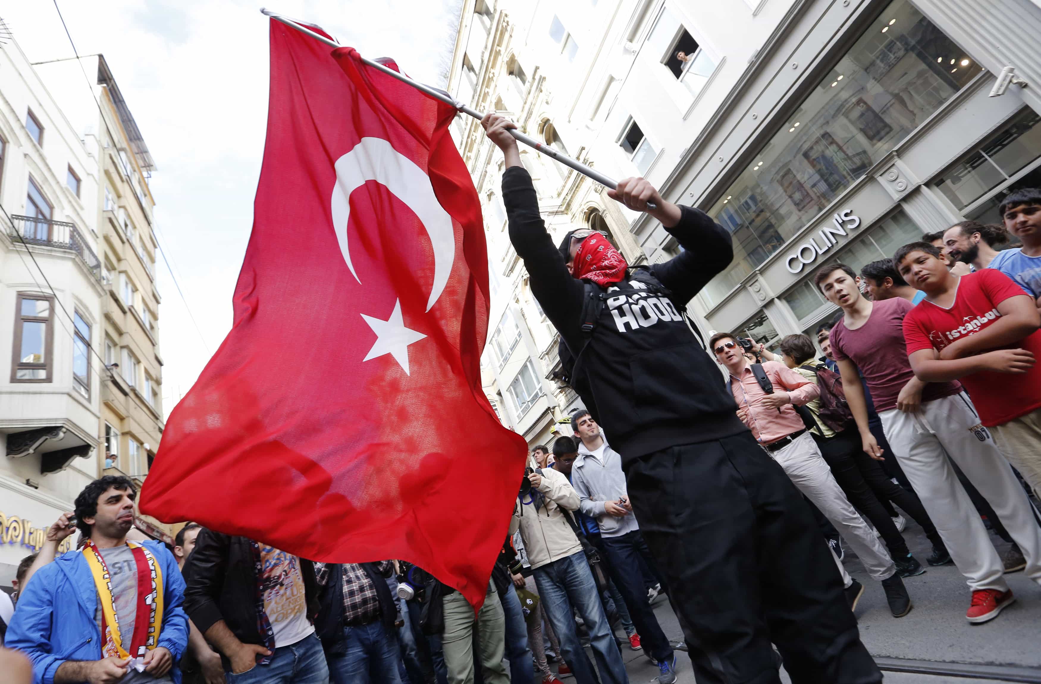 A masked demonstrator waves a Turkish flag during a protest in central Istanbul May 31, 2014 on the first anniversary of nationwide protests, REUTERS/Murad Sezer