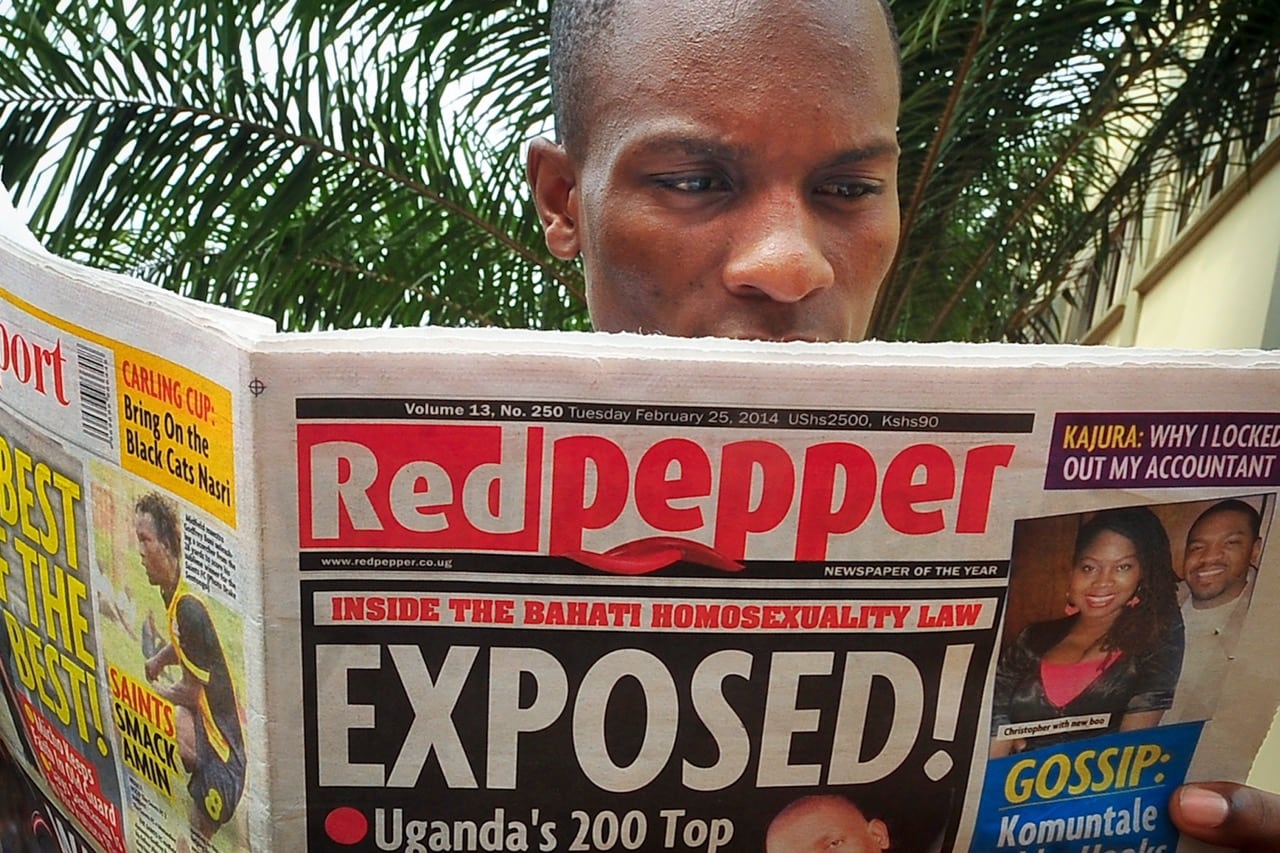 A man reads a copy of the "Red Pepper" tabloid newspaper in Kampala, Uganda, 25 February 2014, AP Photo/Stephen Wandera