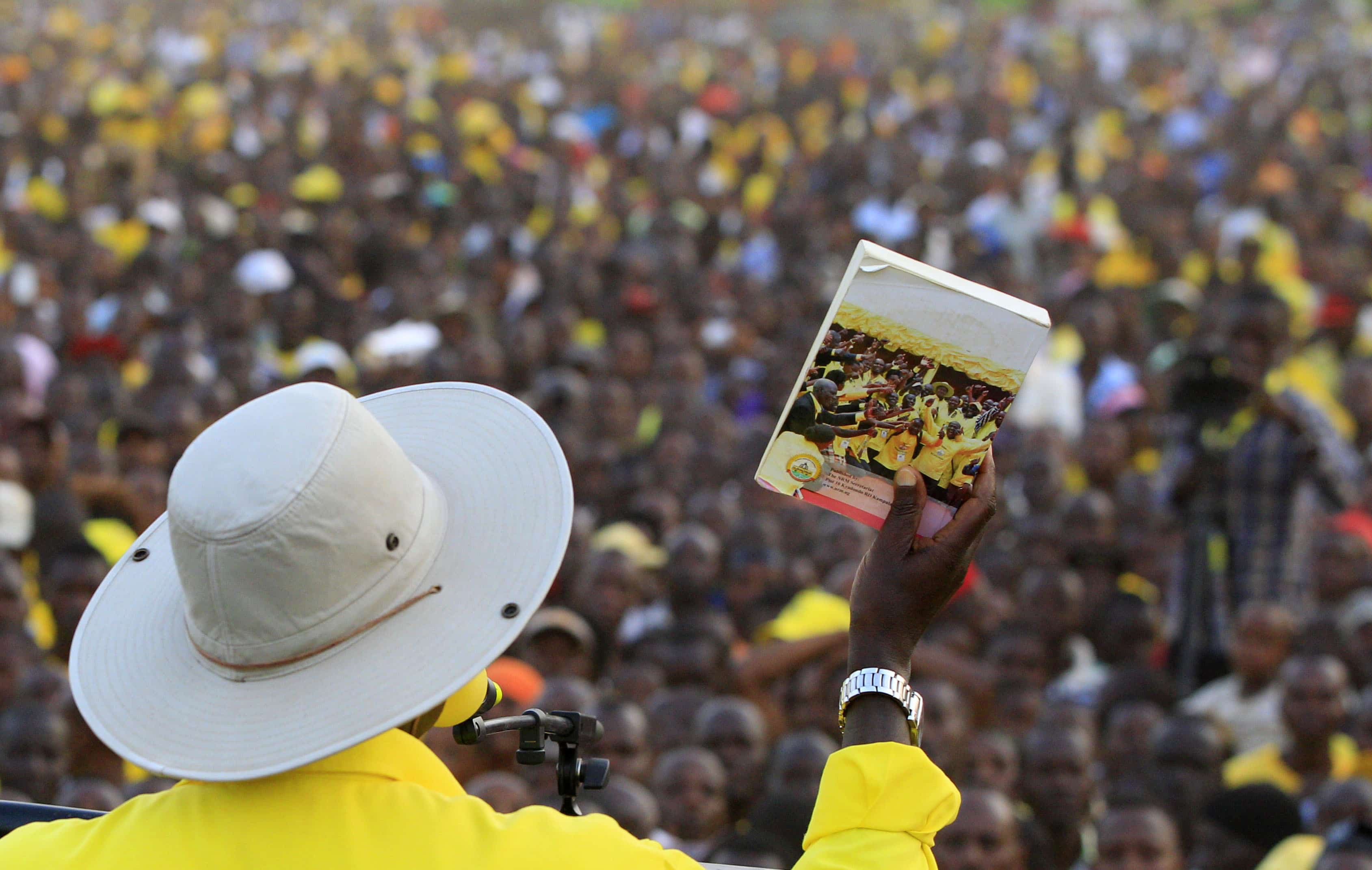 Ugandan president Yoweri Museveni shows his manifesto to supporters during a campaign rally in Entebbe, Uganda, 10 February 2016,  REUTERS/James Akena
