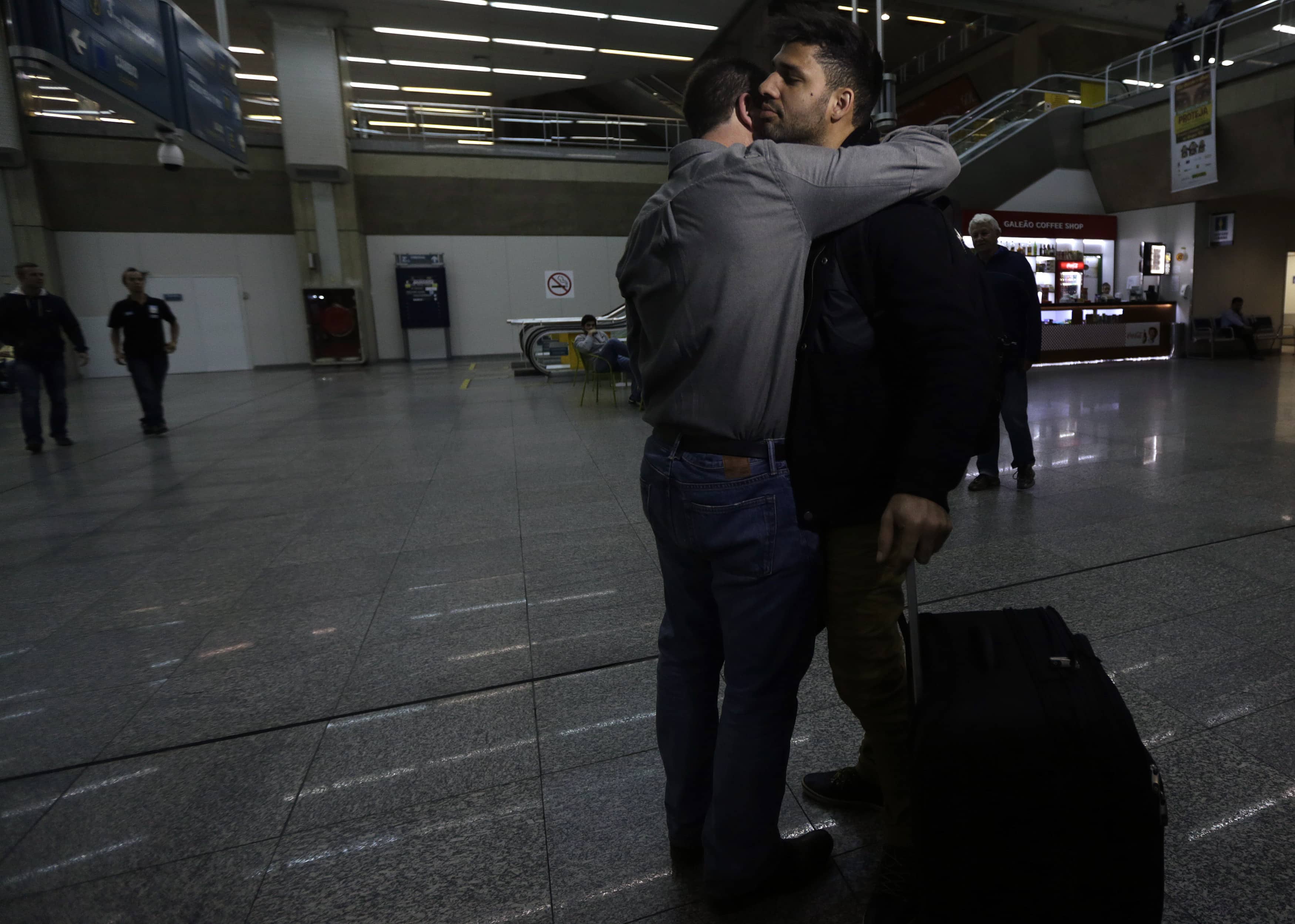 U.S. journalist Glenn Greenwald (front L) embraces his partner David Miranda upon his arrival at Rio de Janeiro's International Airport, 19 August 2013. , REUTERS/Ricardo Moraes