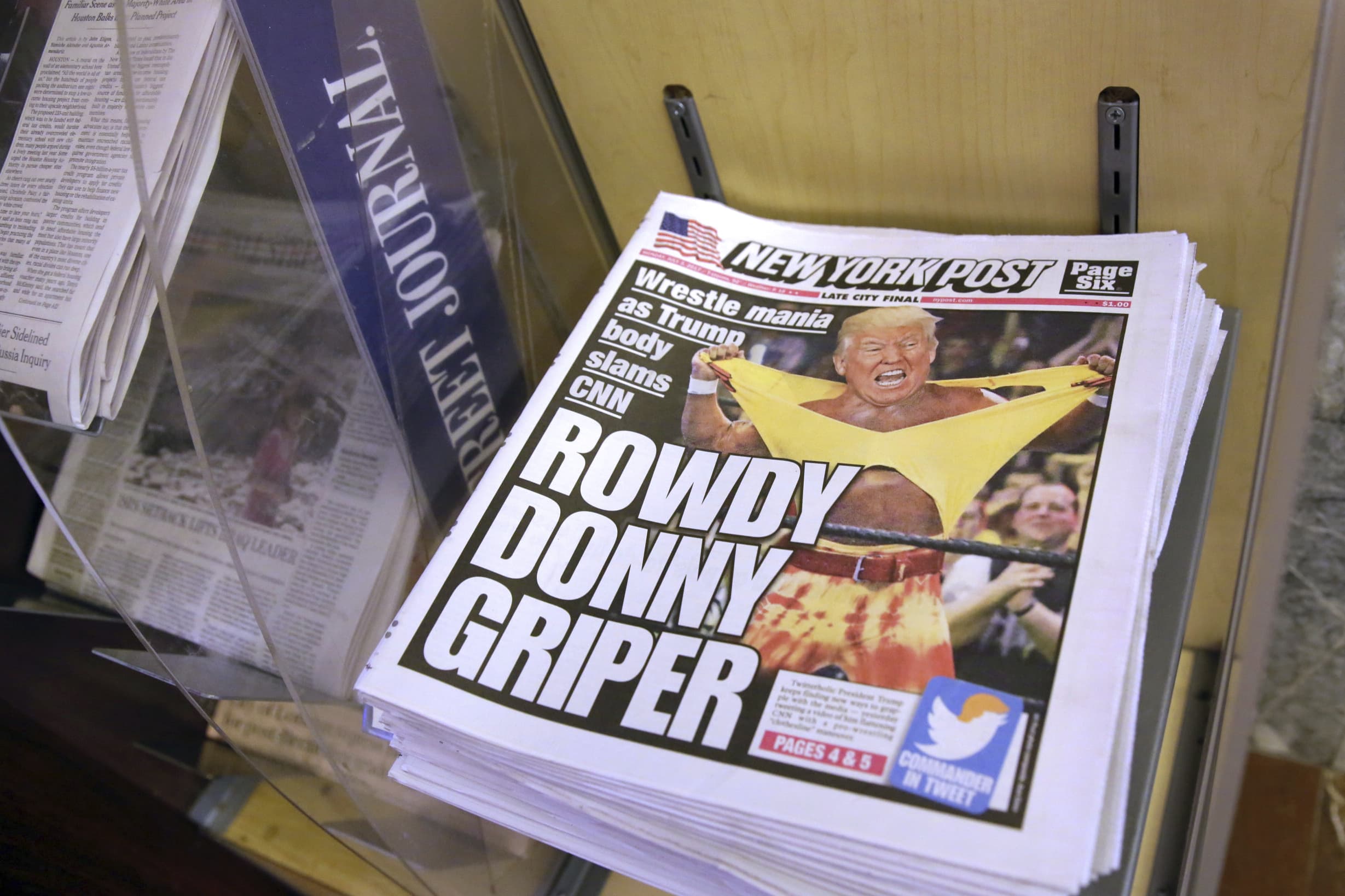 Copies of the "New York Post" with an illustration of President Donald Trump as a professional wrestler on the front page are displayed at a newsstand in New York City, 3 July 2017, AP Photo/Richard Drew