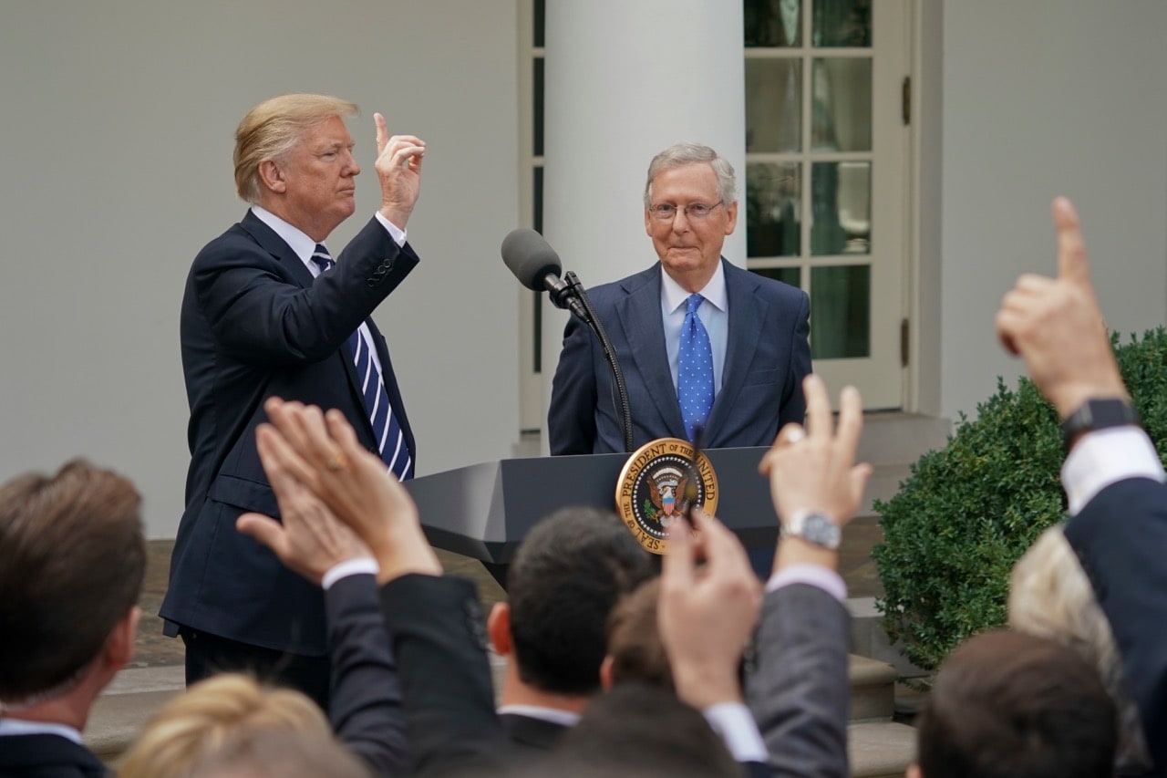 Journalists raise their hands as they wait to be called on to ask a question to President Donald Trump and Senate Majority Leader Mitch McConnell, in the Rose Garden of the White House, 16 October 2017, AP Photo/Pablo Martinez Monsivais