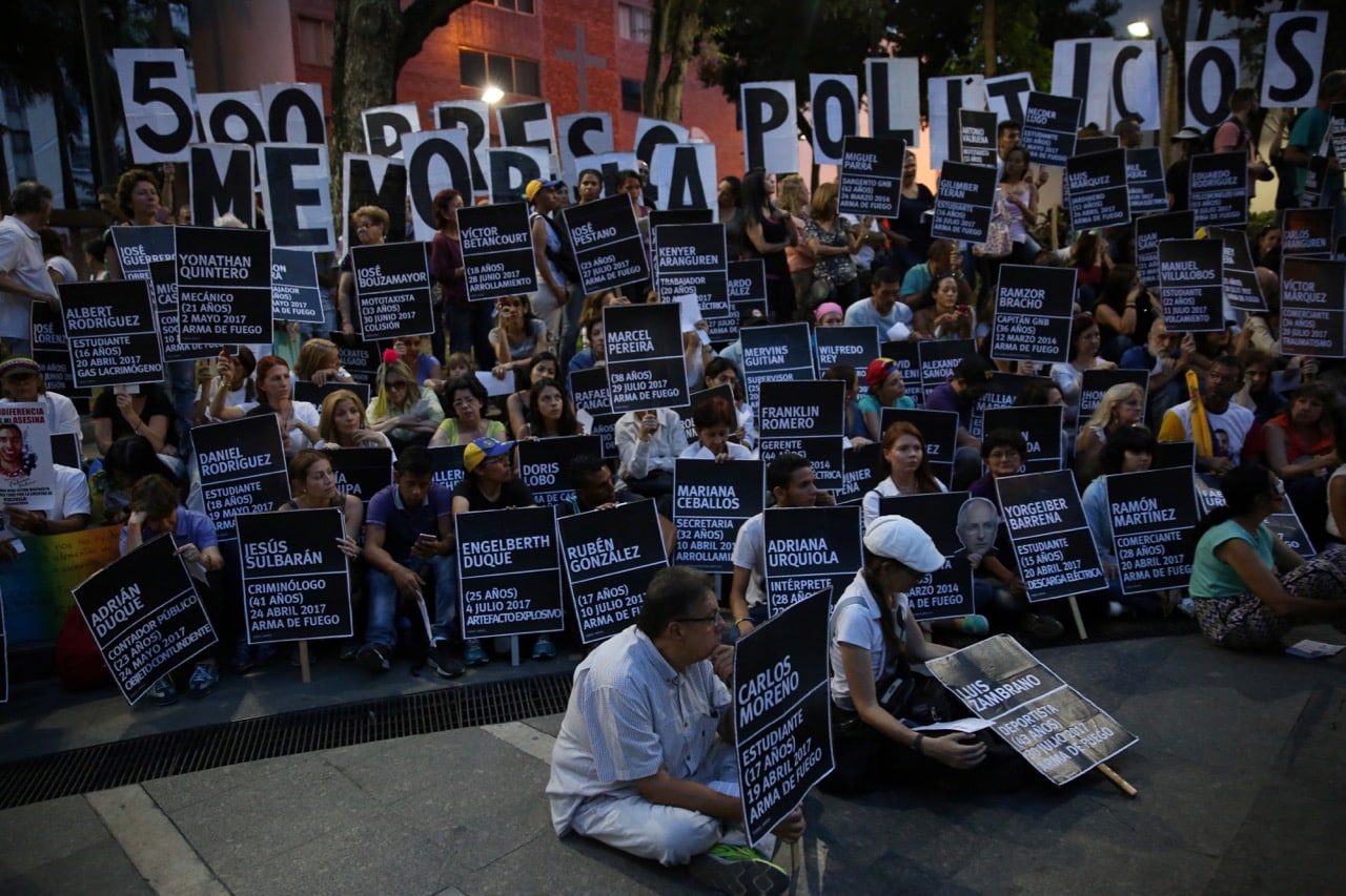 People hold placards at a rally to pay tribute to victims of violence in protests against Venezuelan President Nicolas Maduro's government, in Caracas, Venezuela, 30 August 2017, REUTERS/Andres Martinez Casares