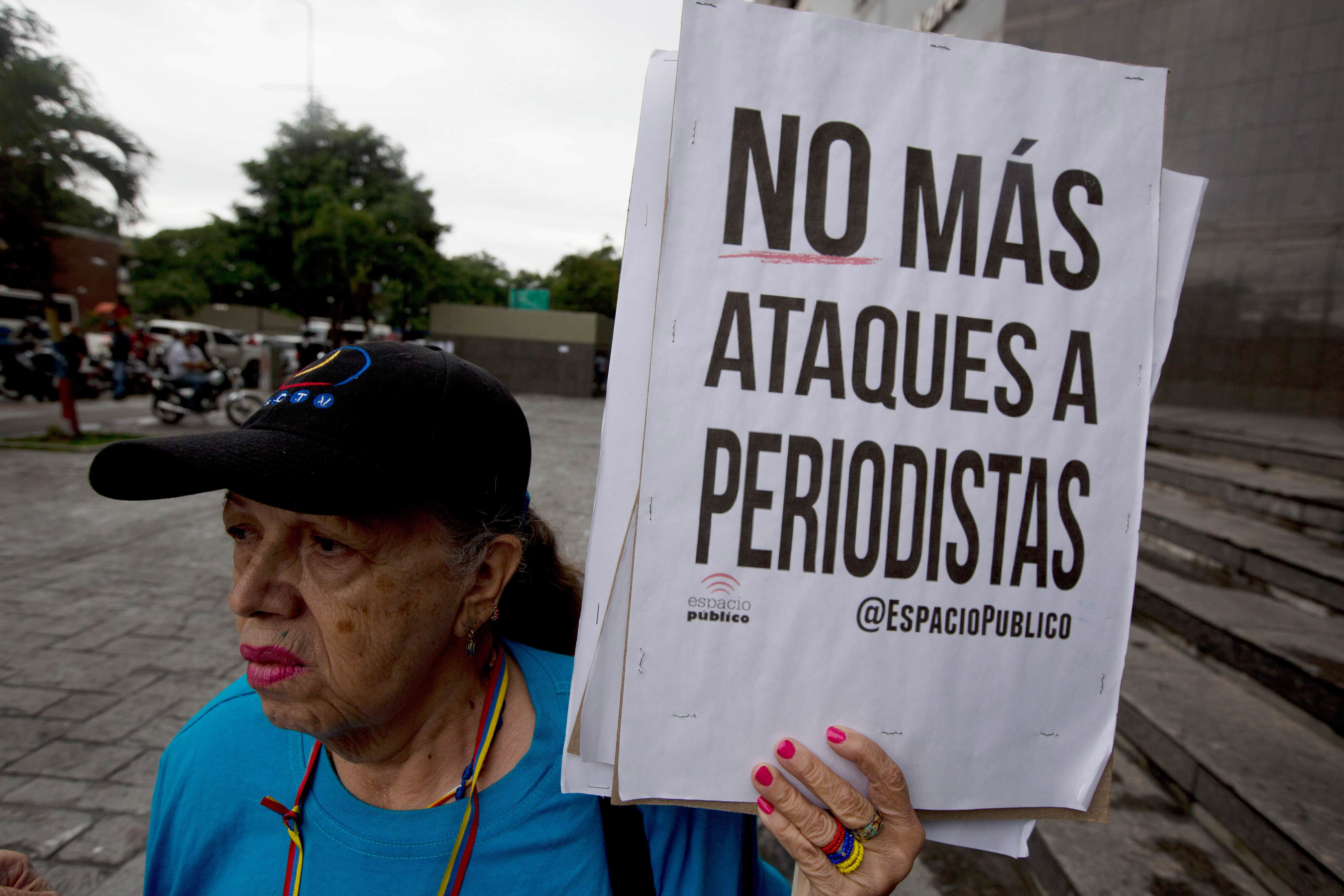 A woman holds a poster during a protest in Caracas, Venezuela, 3 May 2016, AP Photo/Fernando Llano