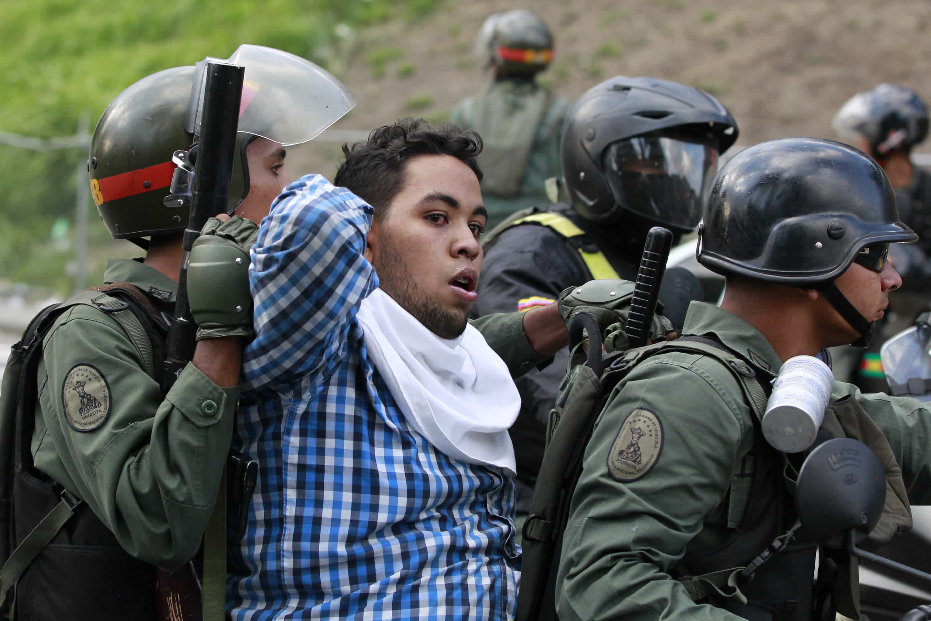 Venezuela's national guards detain an anti-government protester during a protest against President Nicolas Maduro's government in Caracas, 4 June 2014, REUTERS/Christian Veron