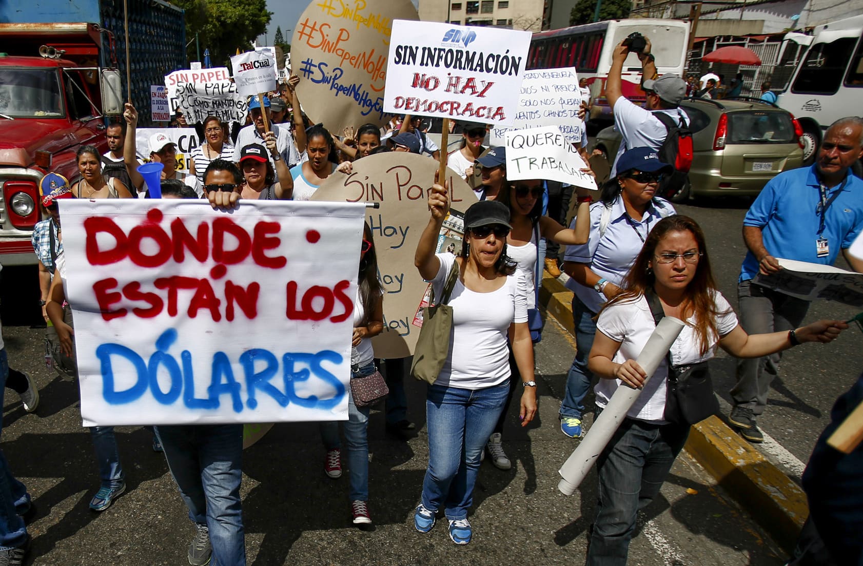 El Impulso employees shout slogans to demand the government free up U.S. dollars for the company to be able to buy newsprint, AP Photo/Alejandro Cegarra