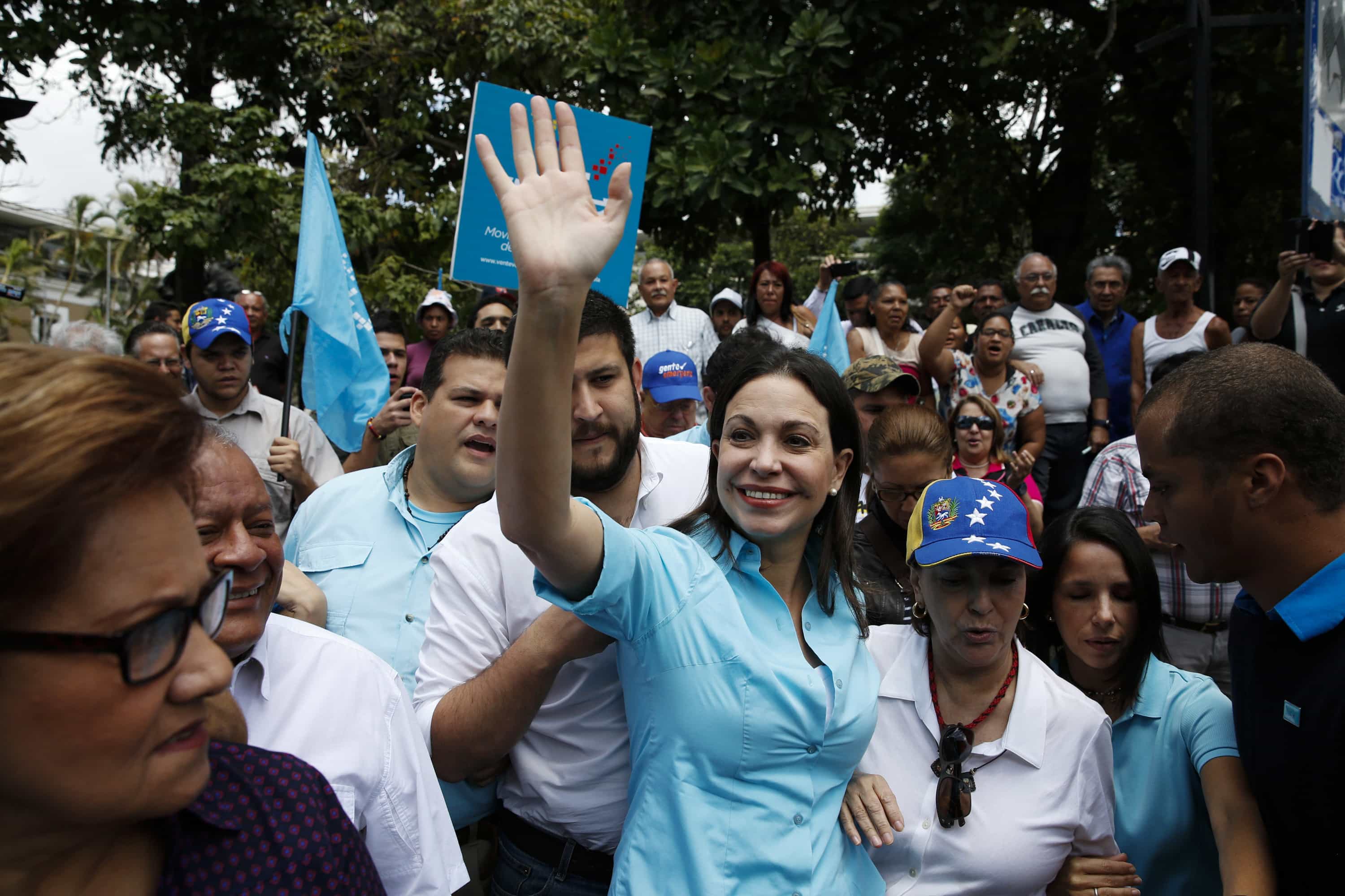 Opposition leader María Corina Machado greets supporters as she arrives to try to register her candidacy for the upcoming parliamentary elections at an office in Los Teques, REUTERS/Carlos Garcia Rawlins