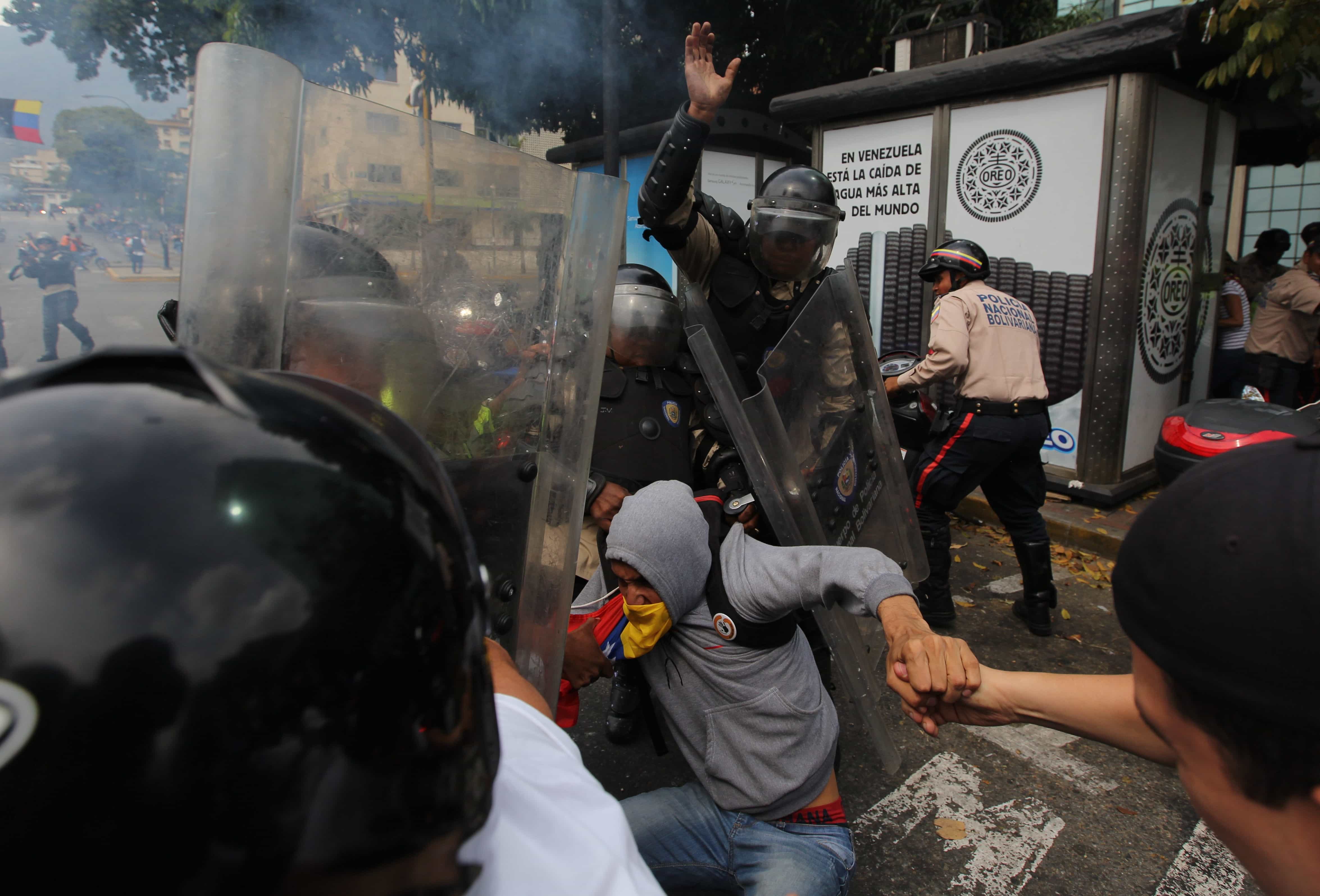 Bolivarian National Police detain a demonstrator during clashes at an anti-government protest in Caracas, Venezuela, 1 April 2014., AP Photo/Fernando Llano