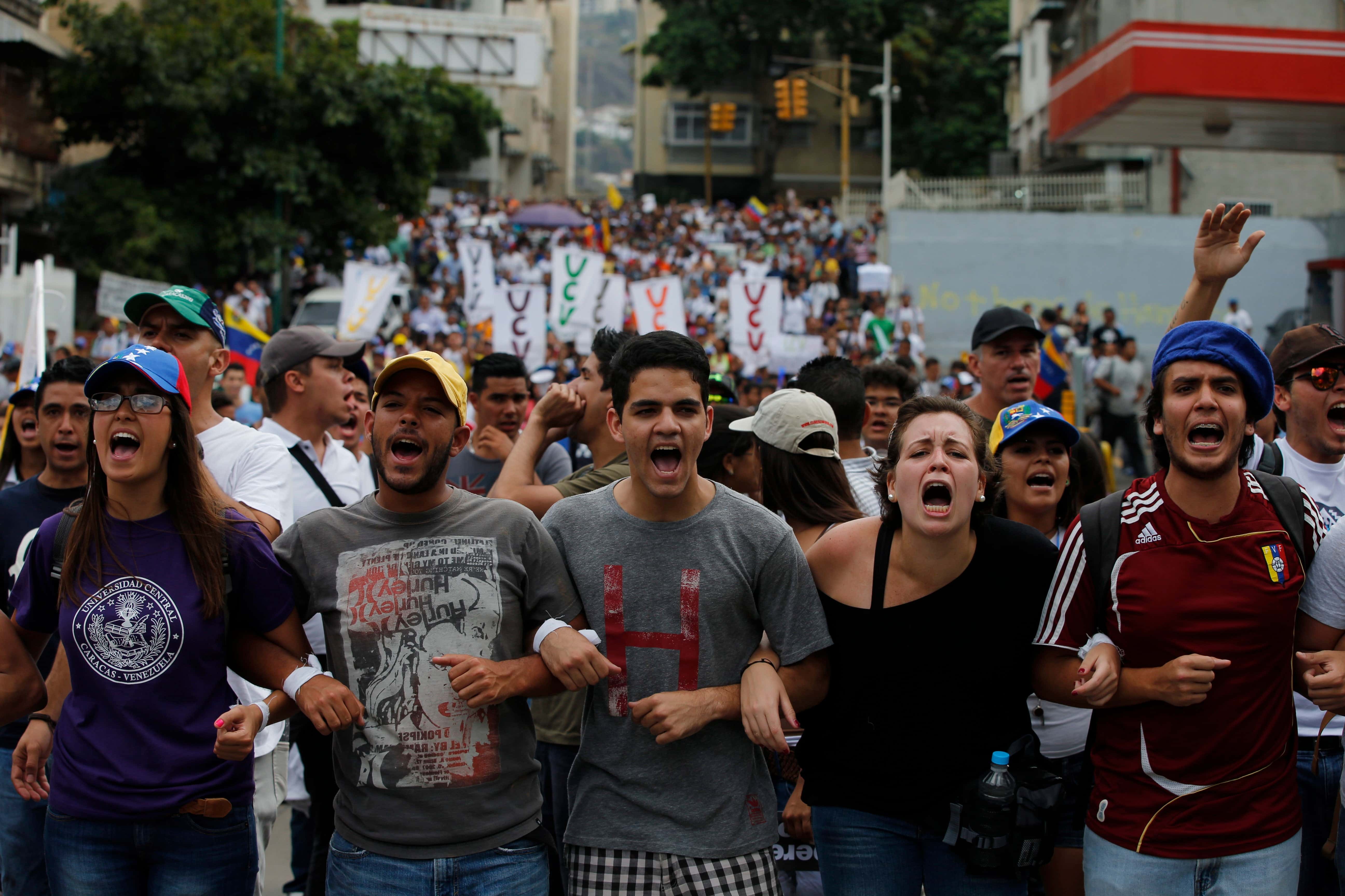 Students at Central University (UCV) in Caracas shout slogans during protest on 12 March 2014, AP Photo/Fernando Llano