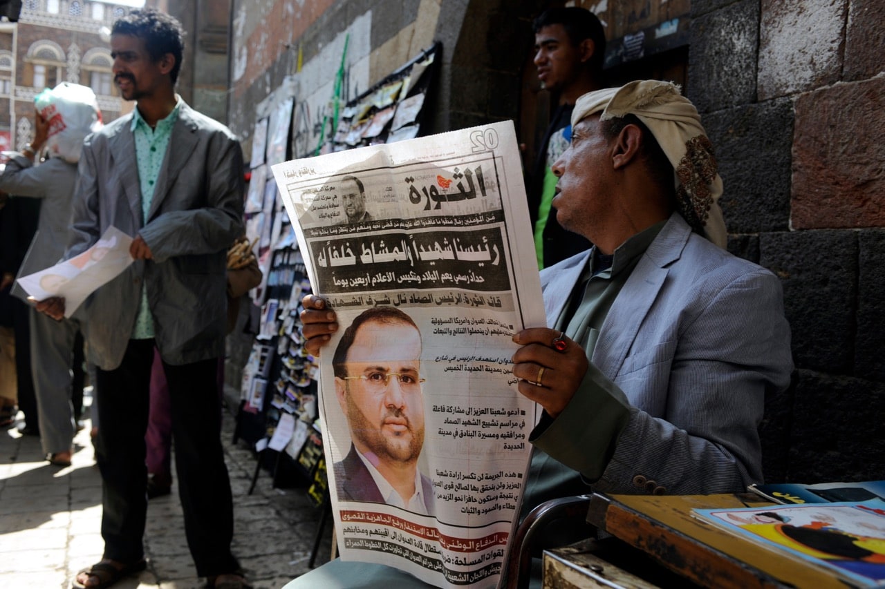 A Yemeni man reads a local newspaper with a front-page picture of the second-highest ranking leader of the Houthi group, in Sana'a, 24 April 2018, Mohammed Hamoud/Getty Images