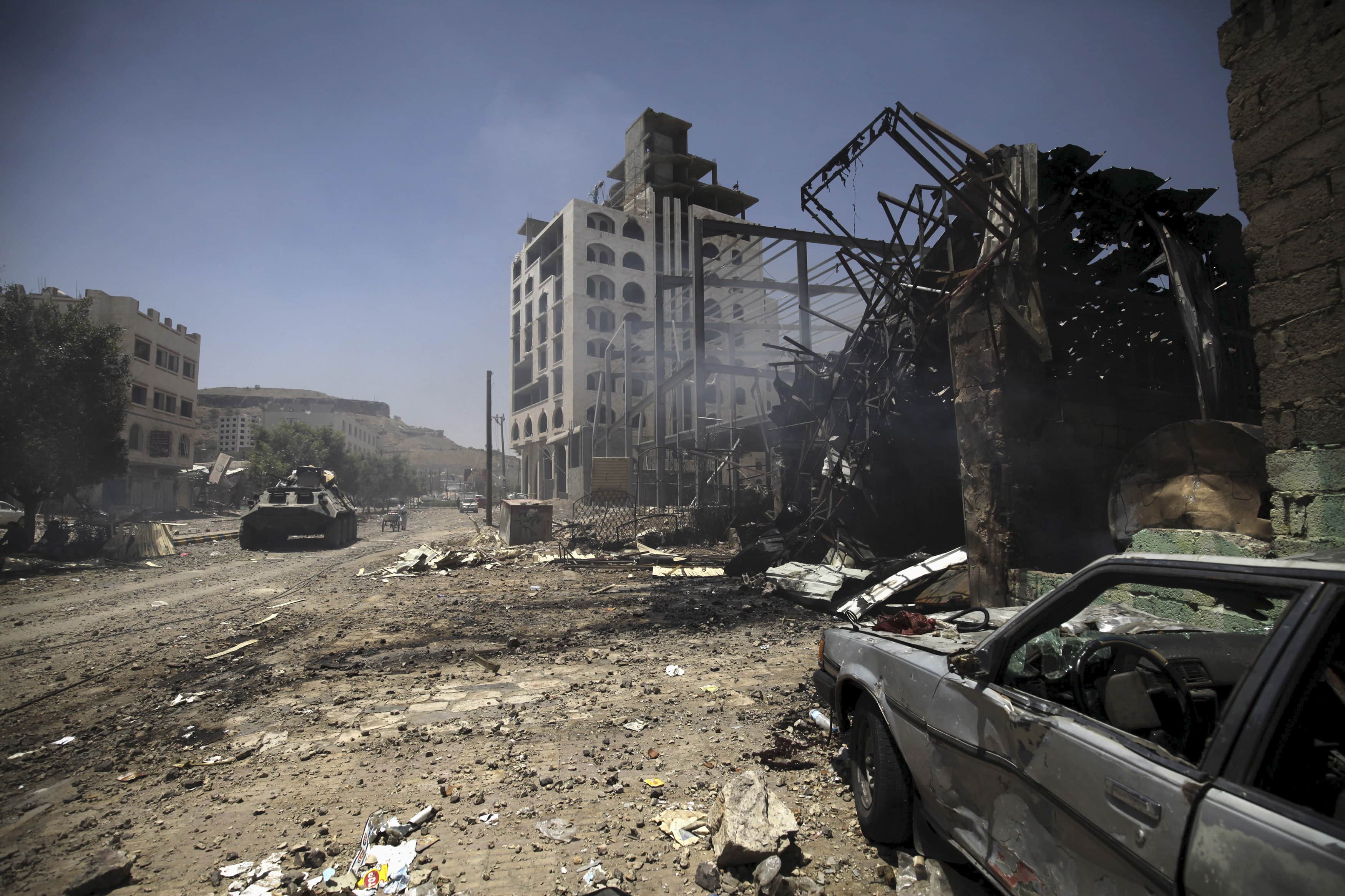 Smoke is seen at a damaged street, caused by an April 20 air strike that hit a nearby army weapons depot, in Sanaa, REUTERS/Mohamed al-Sayaghi