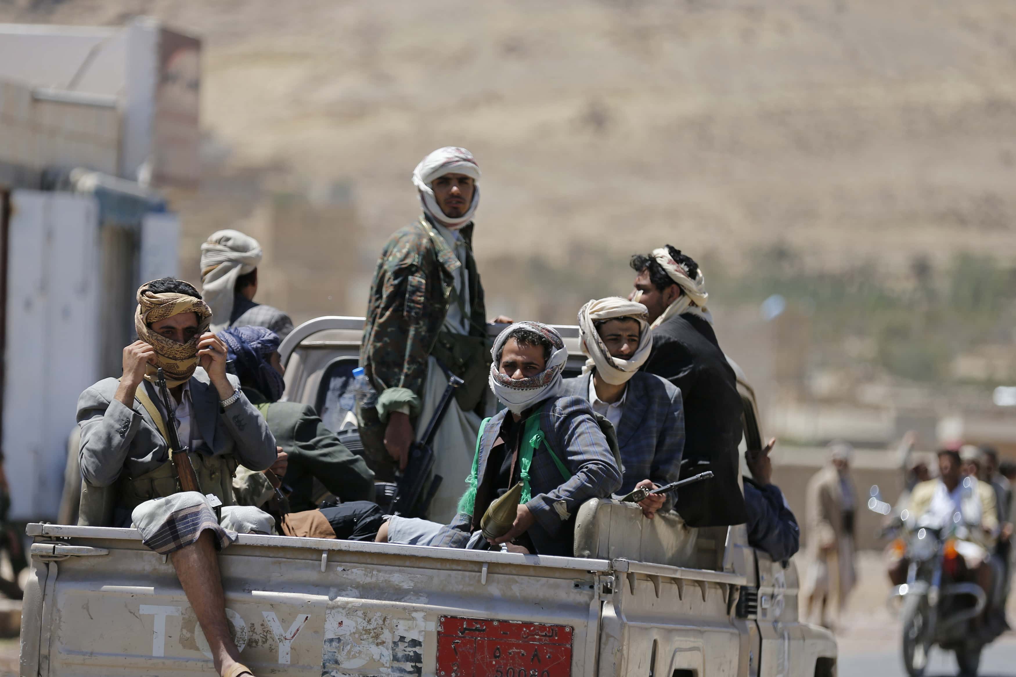 Armed pro-government tribesmen sit at the back of a truck during a tribal gathering denouncing the deployment of militants of the Shi'ite Houthi group, near Amran city, the capital of Amran province north of the Yemeni capital Sanaa on 13 April 2014, REUTERS/Khaled Abdullah