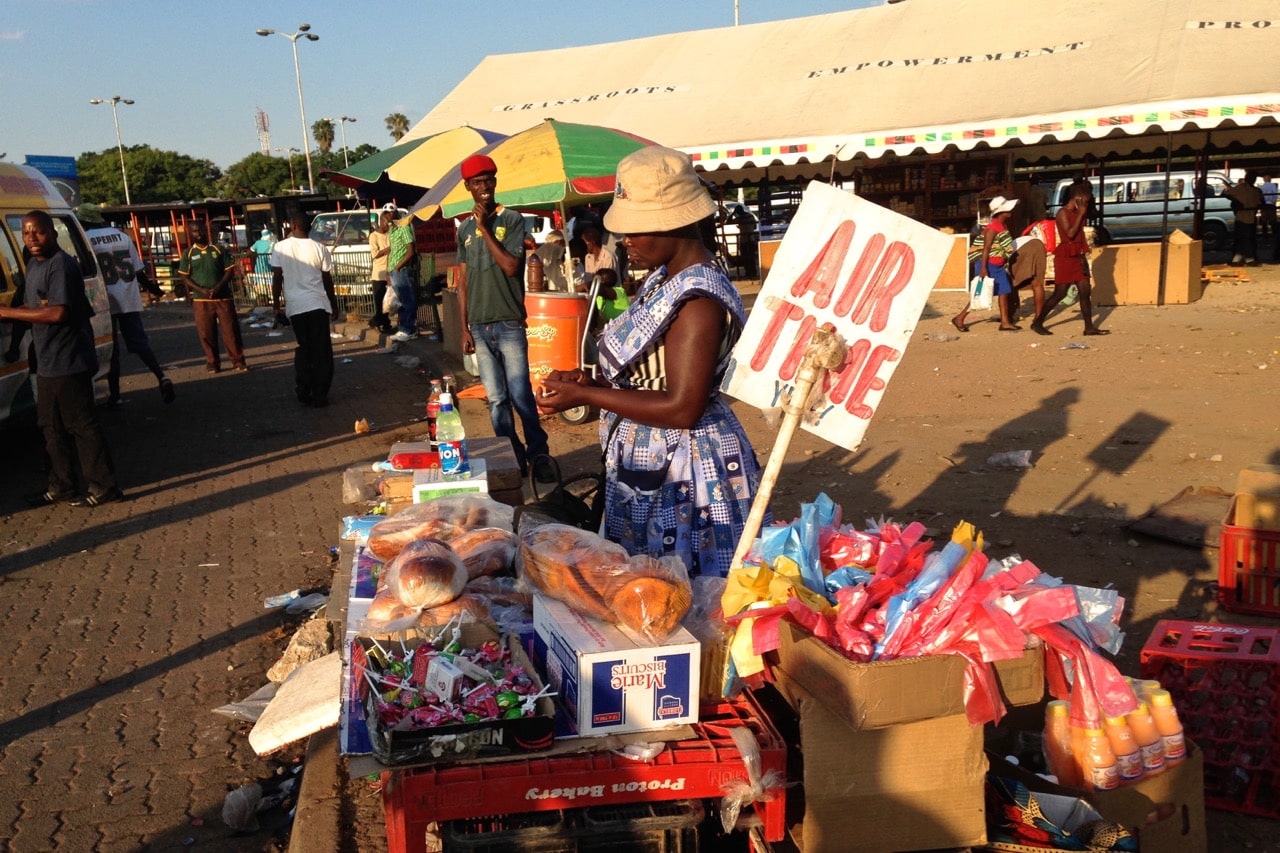 A woman sells airtime for mobile phones in Zimbabwe, Kay McGowan, USAID/Creative Commons license: http://bit.ly/RaejCi