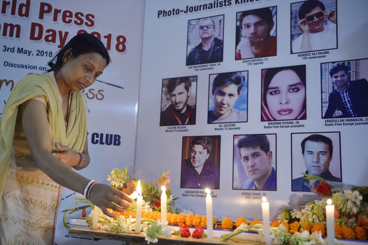 An Indian journalist lights candles during a vigil for ten Afghan journalists who were killed in a suicide bombing in Kabul, during an event marking World Press Freedom Day in Siliguri, India, 3 May 2018, DIPTENDU DUTTA/AFP/Getty Images