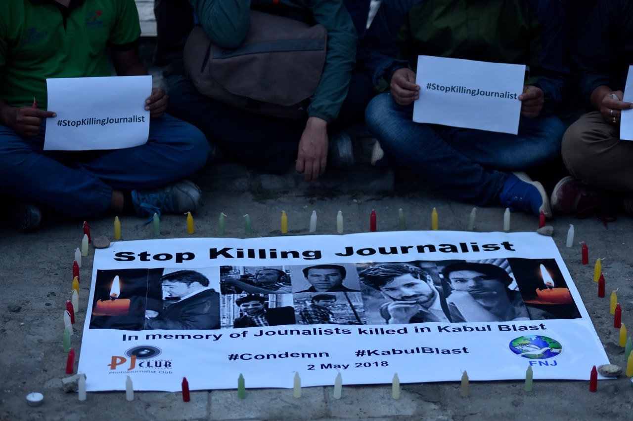 Nepali journalists and photojournalists pay tribute to the journalists killed in a Kabul, Afghanistan attack, during a vigil in Kathmandu, Nepal, 2 May 2018, Narayan Maharjan/NurPhoto via Getty Images