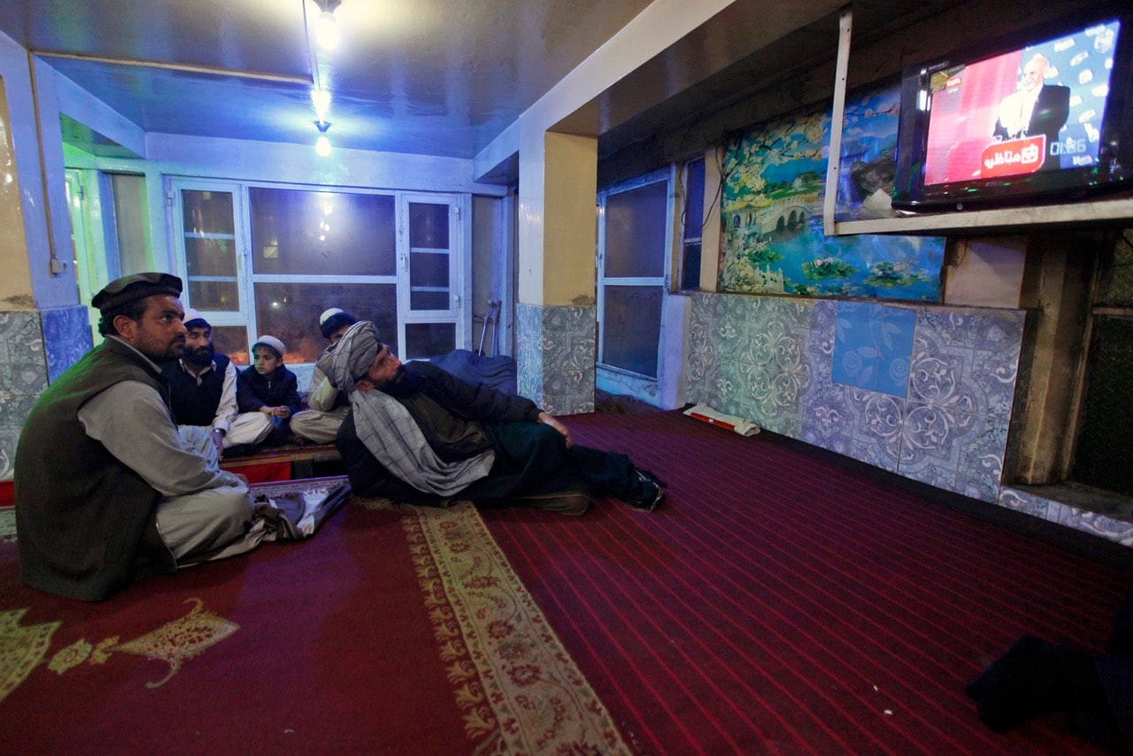 Afghans watch TV at a restaurant in Kabul, 4 February 2014, REUTERS/Mohammad Ismail