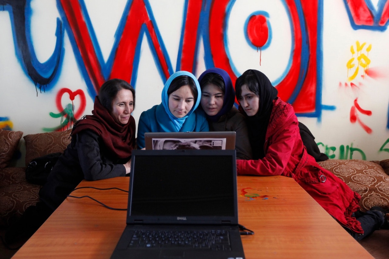 Young women work at the first Internet cafe for women in Kabul, Afghanistan, 8 March 2012, REUTERS/Mohammad Ismail