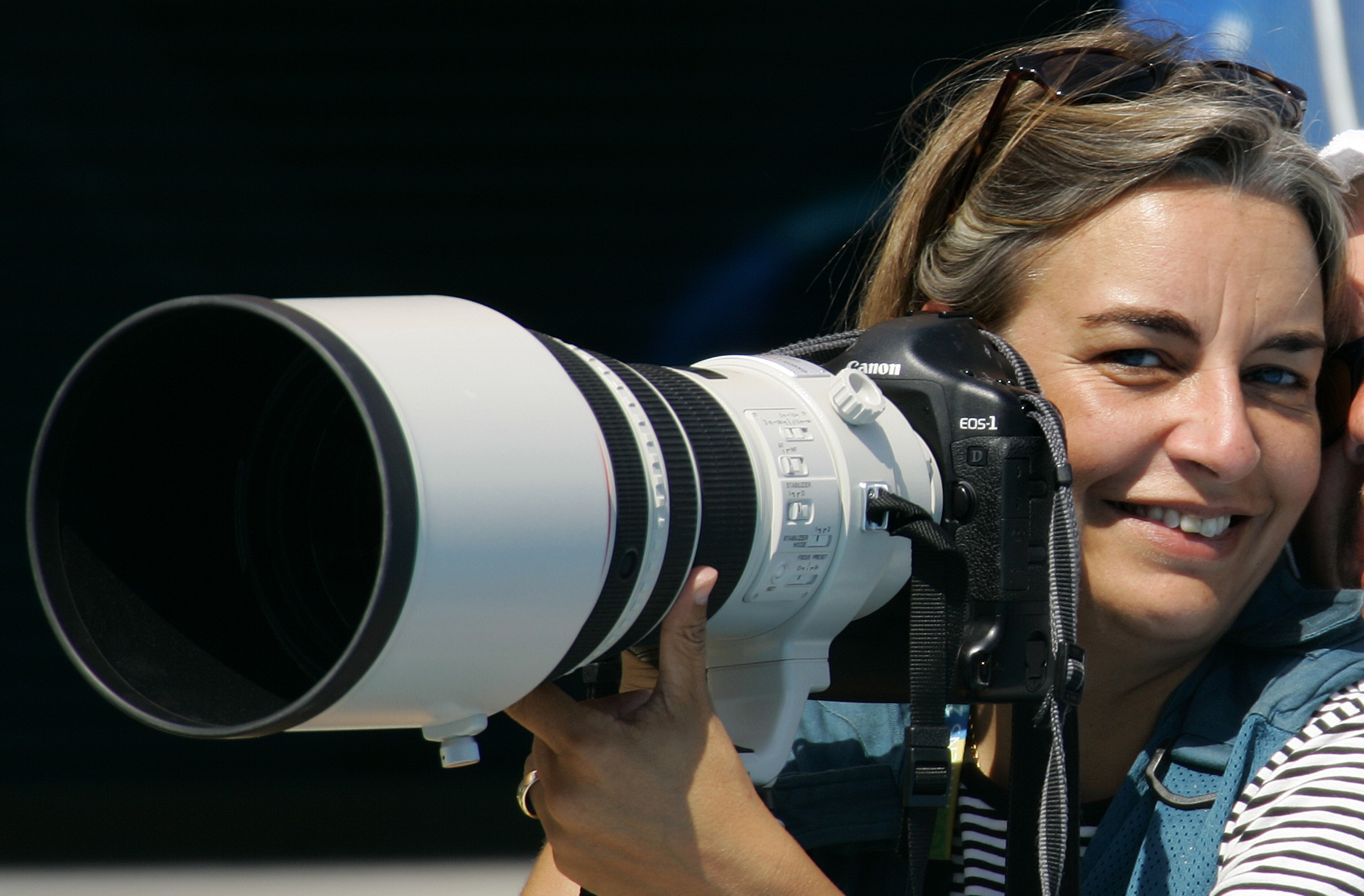 AP photographer Anja Niedringhaus laughs as she attends a swimming event at the 2004 Olympic Games in Athens, 21 August 2004, REUTERS/STAFF