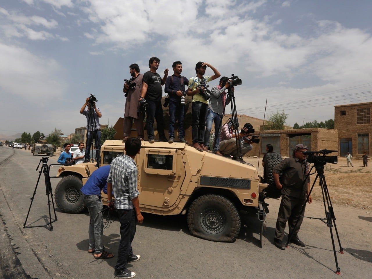 Journalists on top of a military Humvee at the site of a suicide attack in Kabul, 30 June 2016 , REUTERS/Omar Sobhani