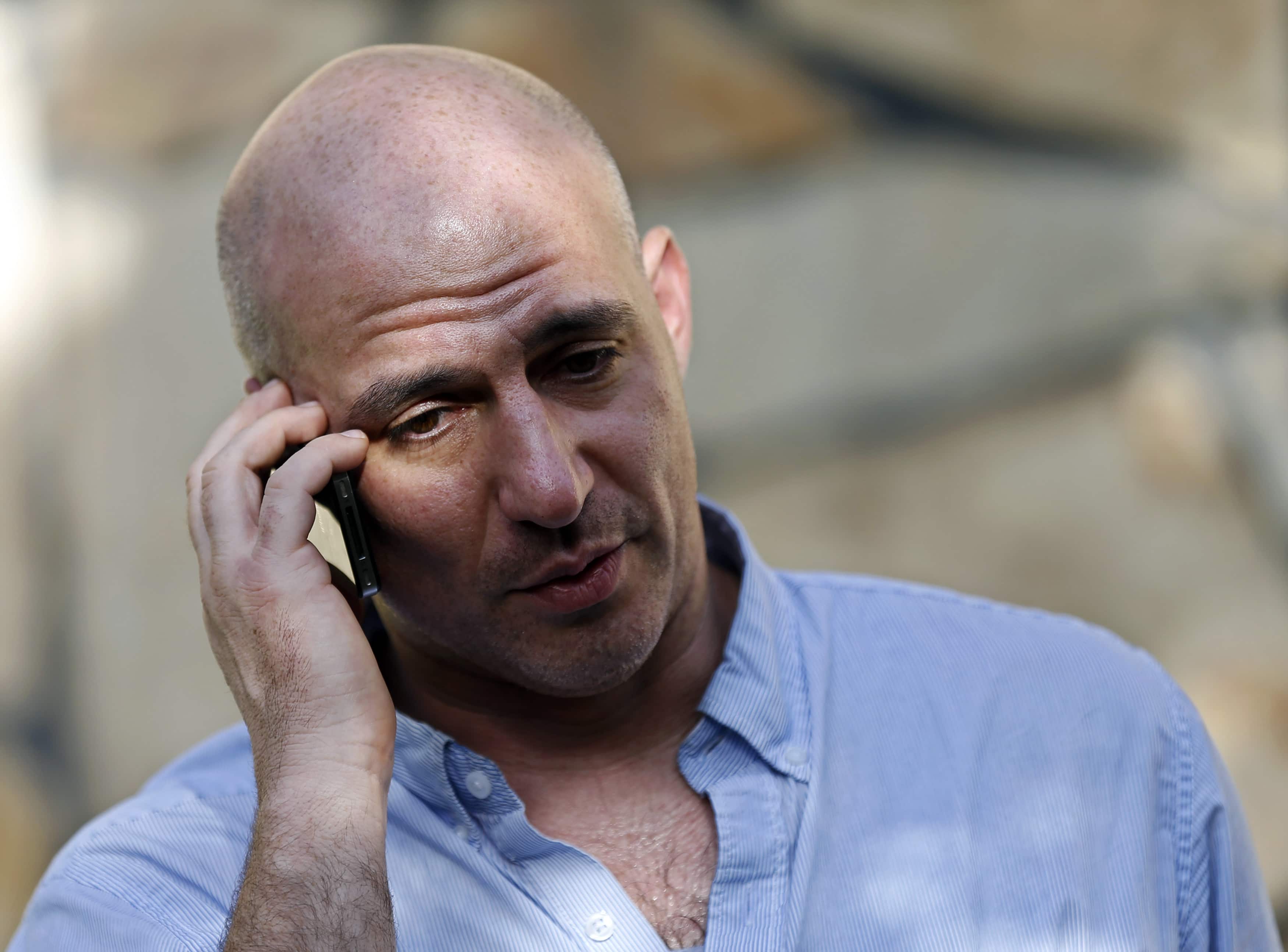 New York Times reporter Matthew Rosenberg, 40, talks on his phone after an interview in Kabul, 20 August 2014, REUTERS/Mohammad Ismail