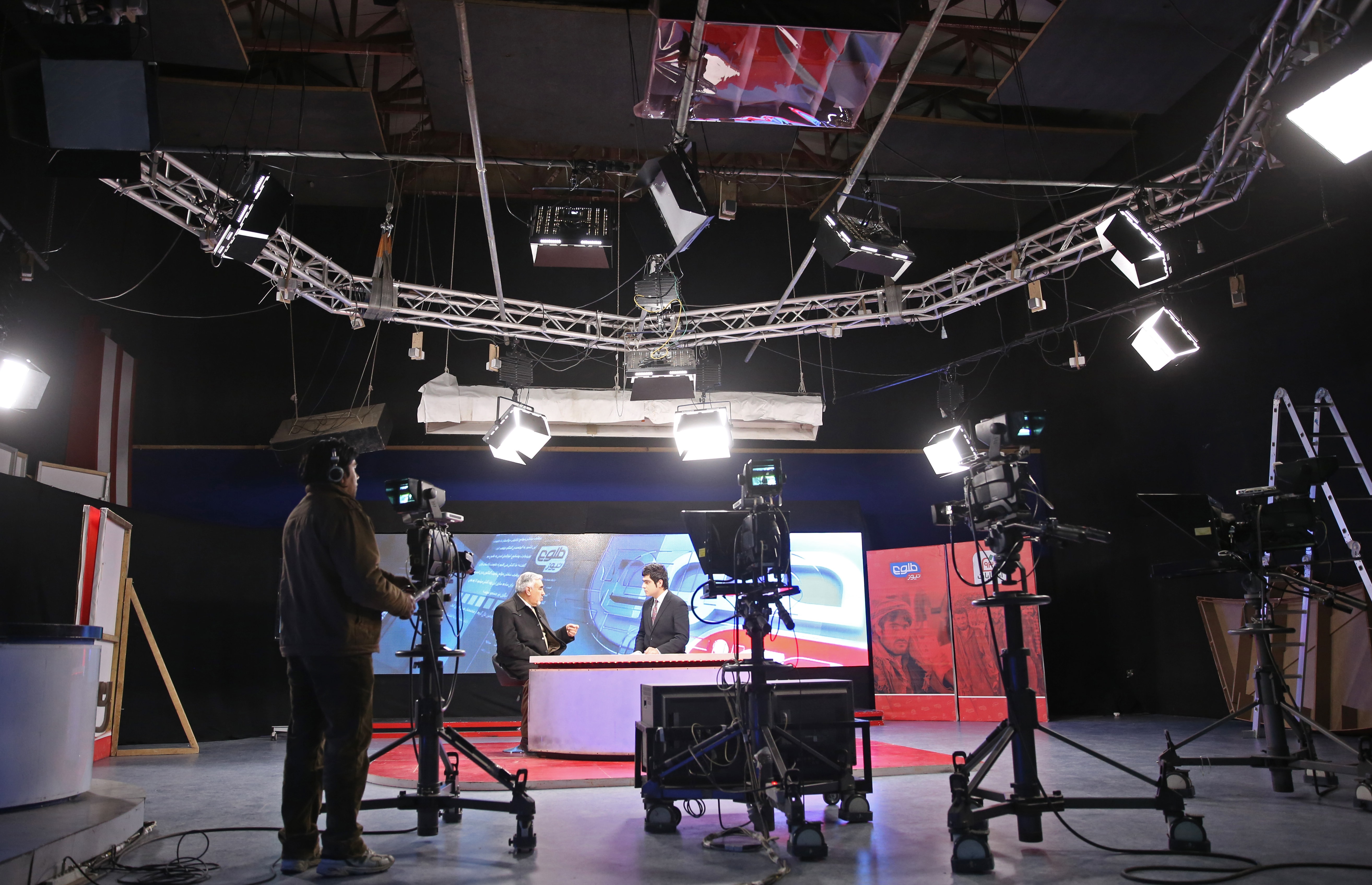 In this 3 February 2014 photo, Tolo TV staff work in a studio at the Tolo TV building in Kabul, Afghanistan, AP Photo/Massoud Hossaini