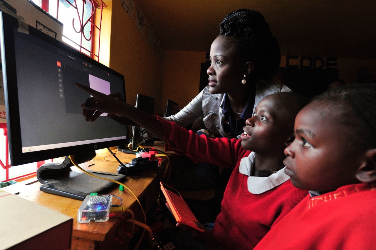 A teacher shows pupils at the Kibera School for Girls how to use a computer, Nairobi, Kenya, 19 May 2016, SIMON MAINA/AFP/Getty Images
