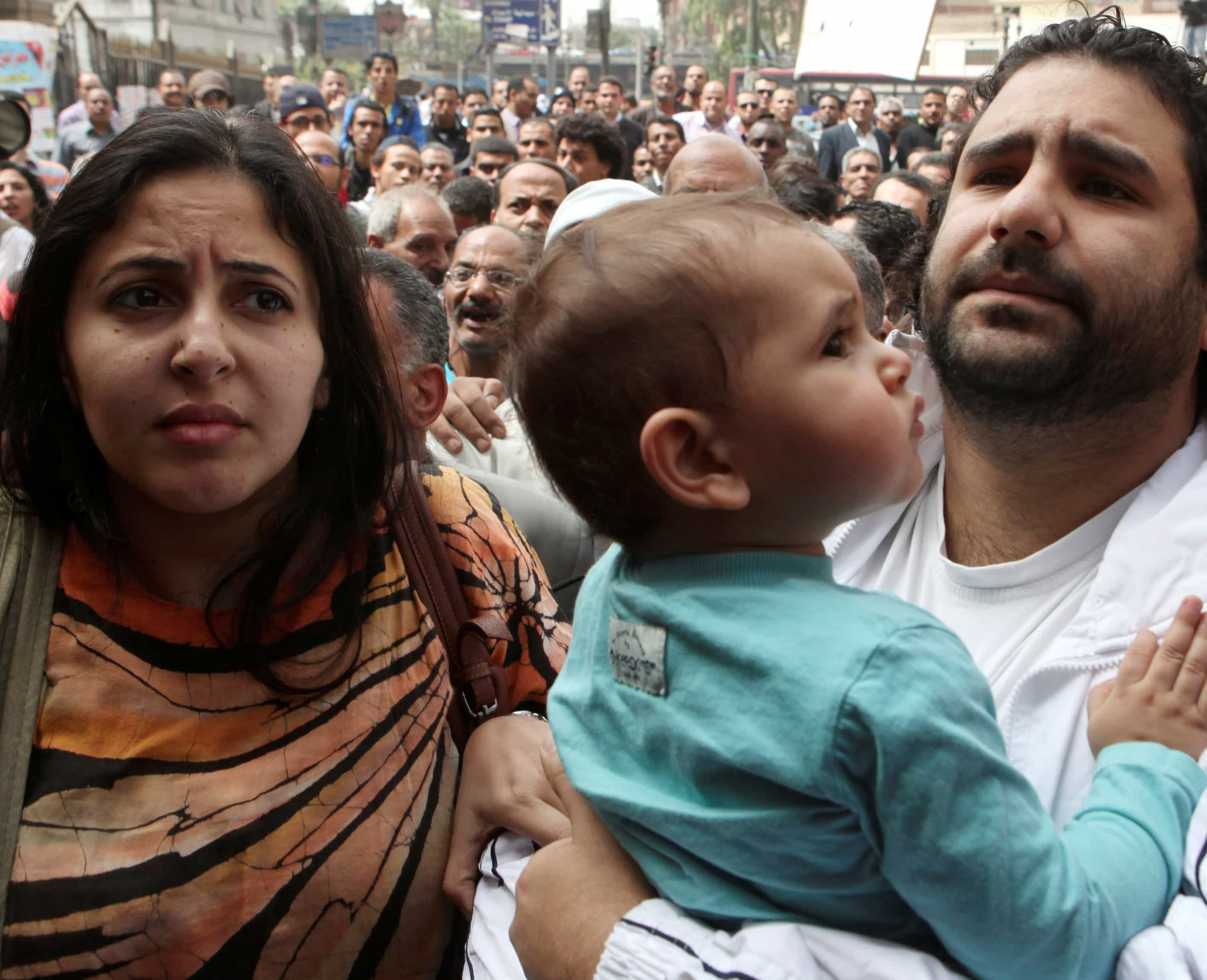 Alaa Abdel Fattah (R), a blogger summoned by the public prosecutor, arrives with his wife and child to the office in Cairo on 26 March 2013, REUTERS/Asmaa Waguih