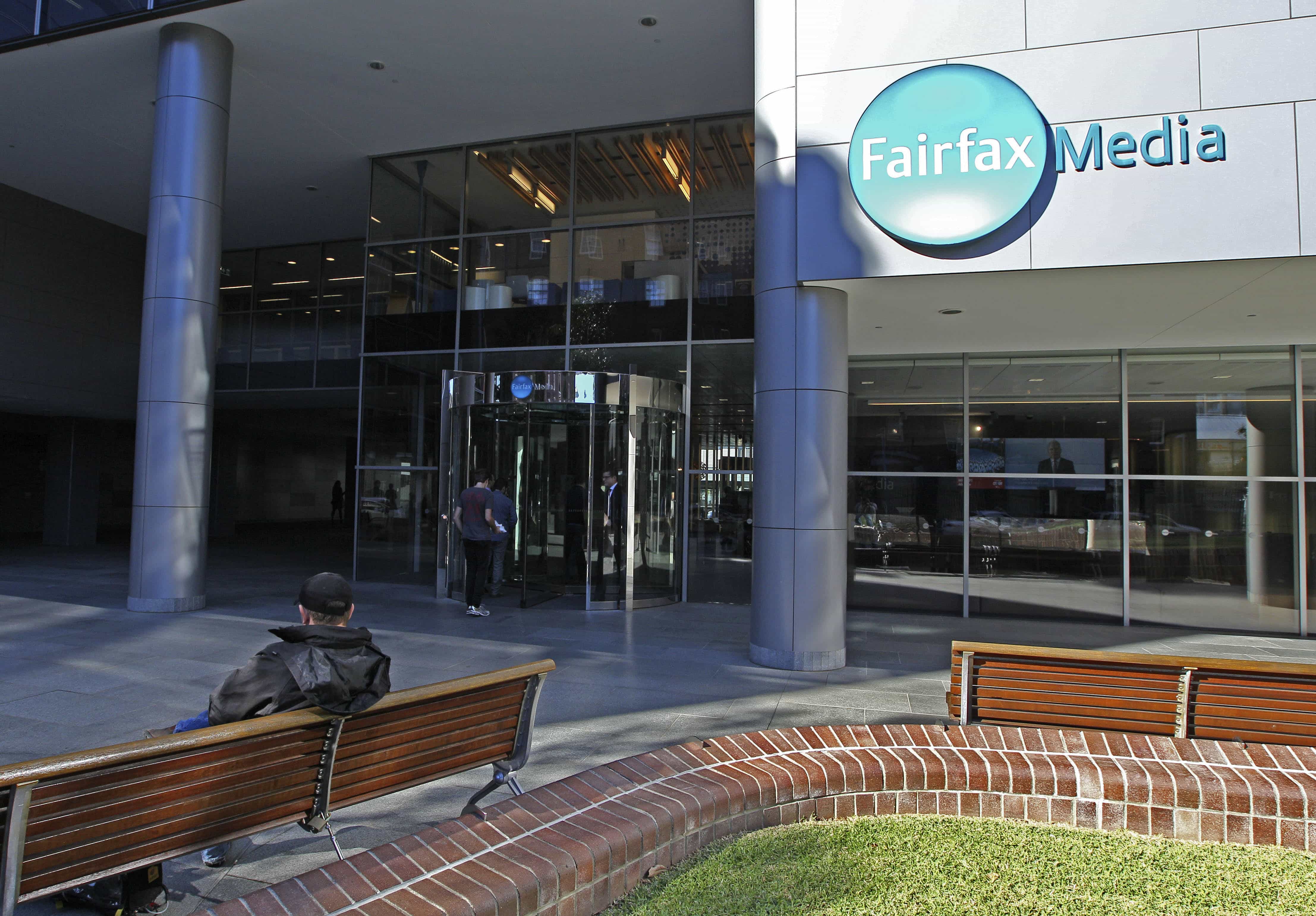 A man sits on a bench outside the Fairfax Media headquarters in Sydney, Australia., Rick Rycroft, AP