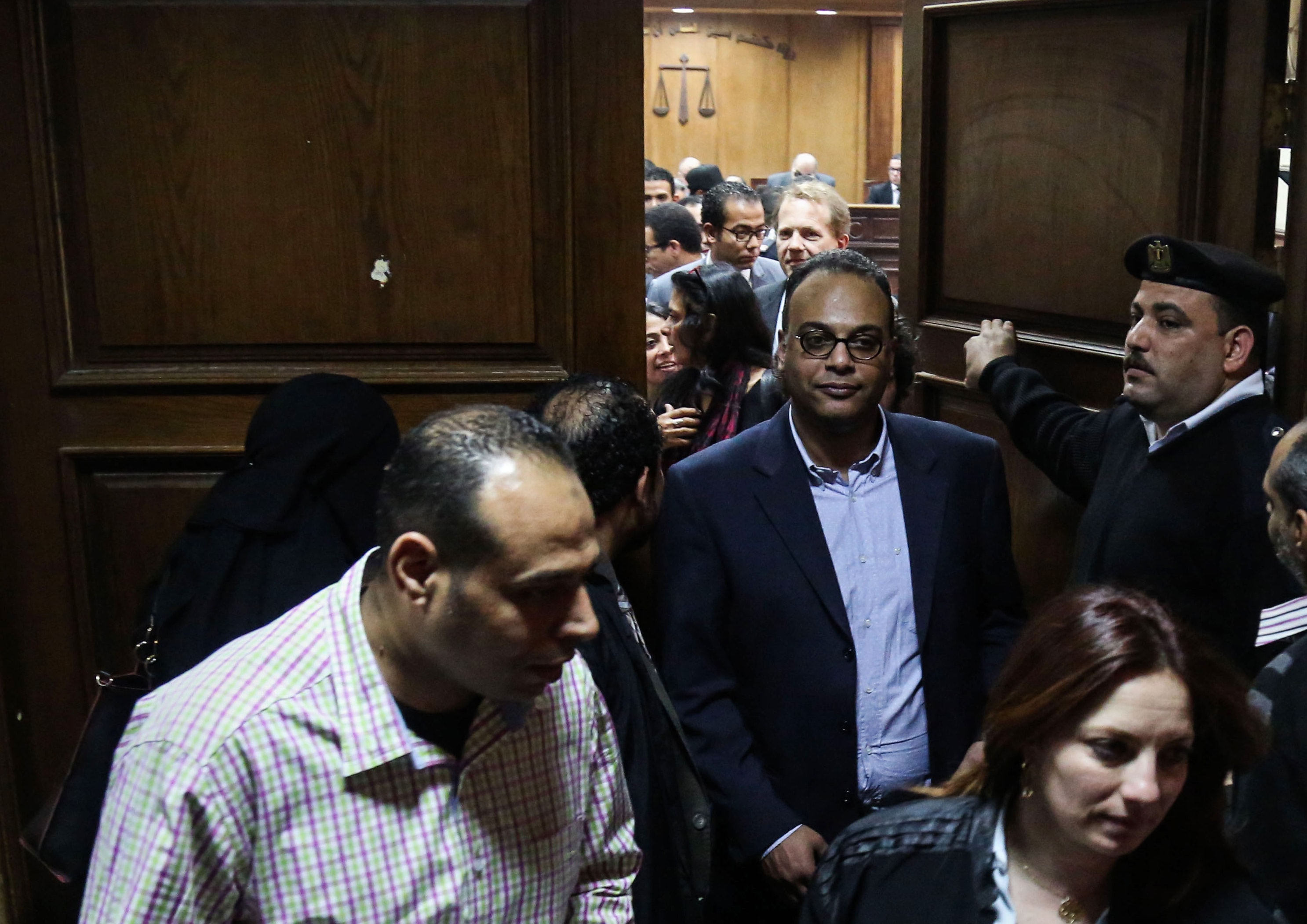 Investigative journalist Hossam Baghat, center, leaves a courtroom at the Cairo Criminal Court after the court postponed a decision on whether to implement an order to freeze his assets over allegations of illegal foreign funding, in Cairo, Egypt Thursday, March 24, 2016., AP Photo/Mohamed Elraai