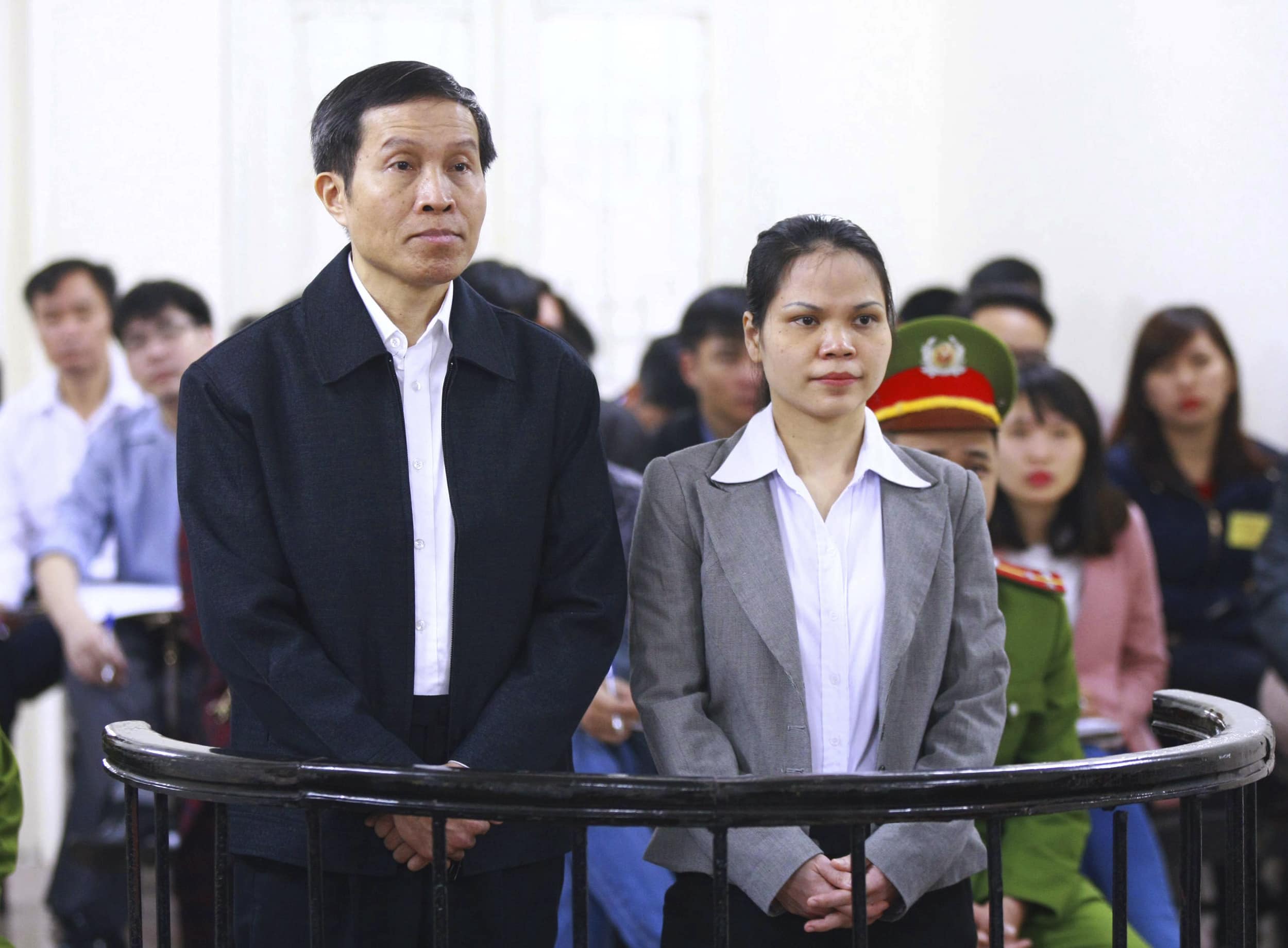 Prominent Vietnamese blogger Nguyen Huu Vinh, left, and his assistant Nguyen Thi Minh Thuy stand together during a trial in Hanoi, Vietnam, Wednesday, March 23, 2016., AP/Bui Doan Tan