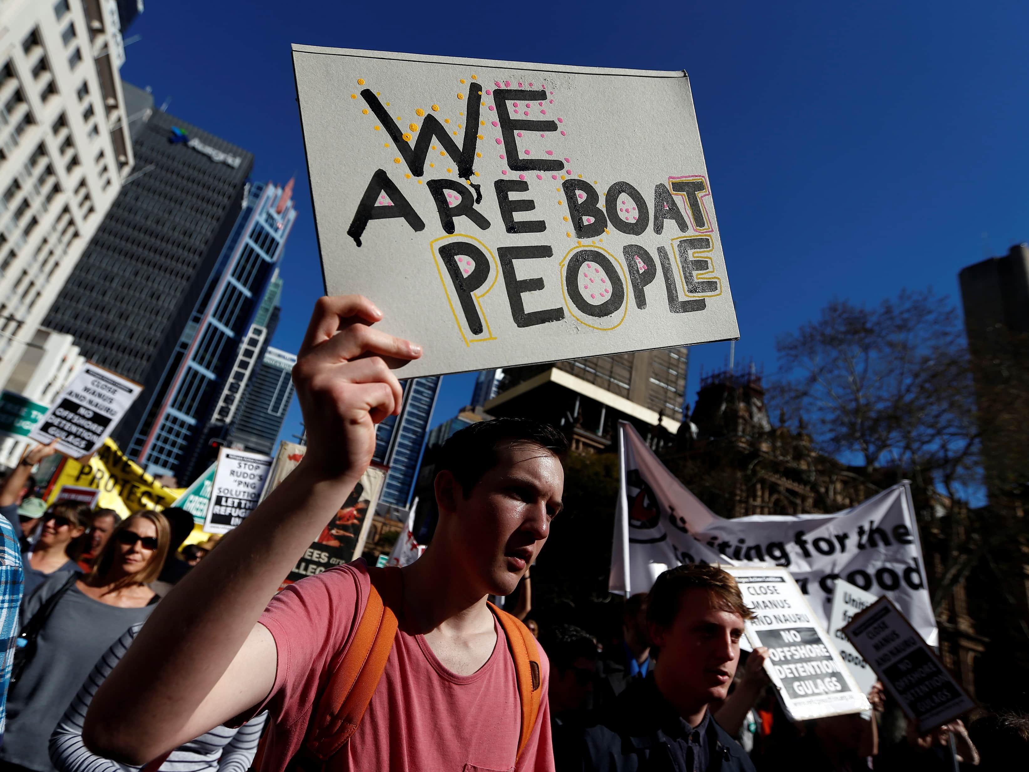 A man holds a placard during a protest against the Australian government's policy on asylum-seekers in central Sydney, 24 August 2013, REUTERS/Daniel Munoz