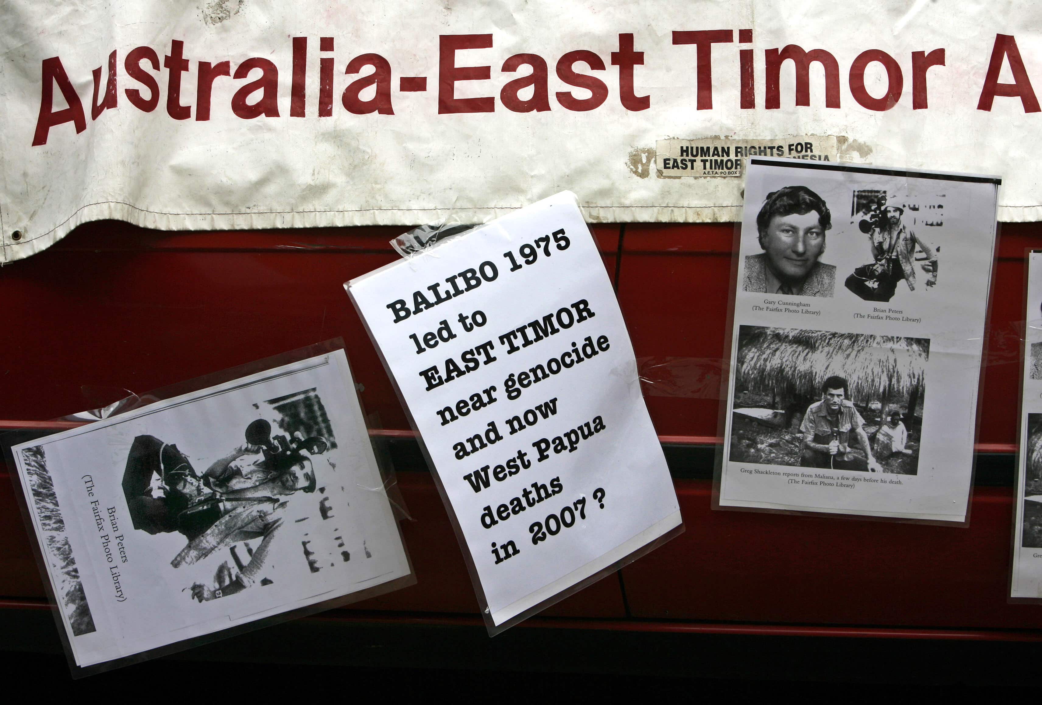 Placards stuck to banners stand outside the Glebe Coroner's Court in Sydney 8 May 2007, where the inquest into the death of Brian Peters, one of five Australian-based journalists killed by Indonesian troops at Balibo in East Timor in 1975, was held, REUTERS/David Gray