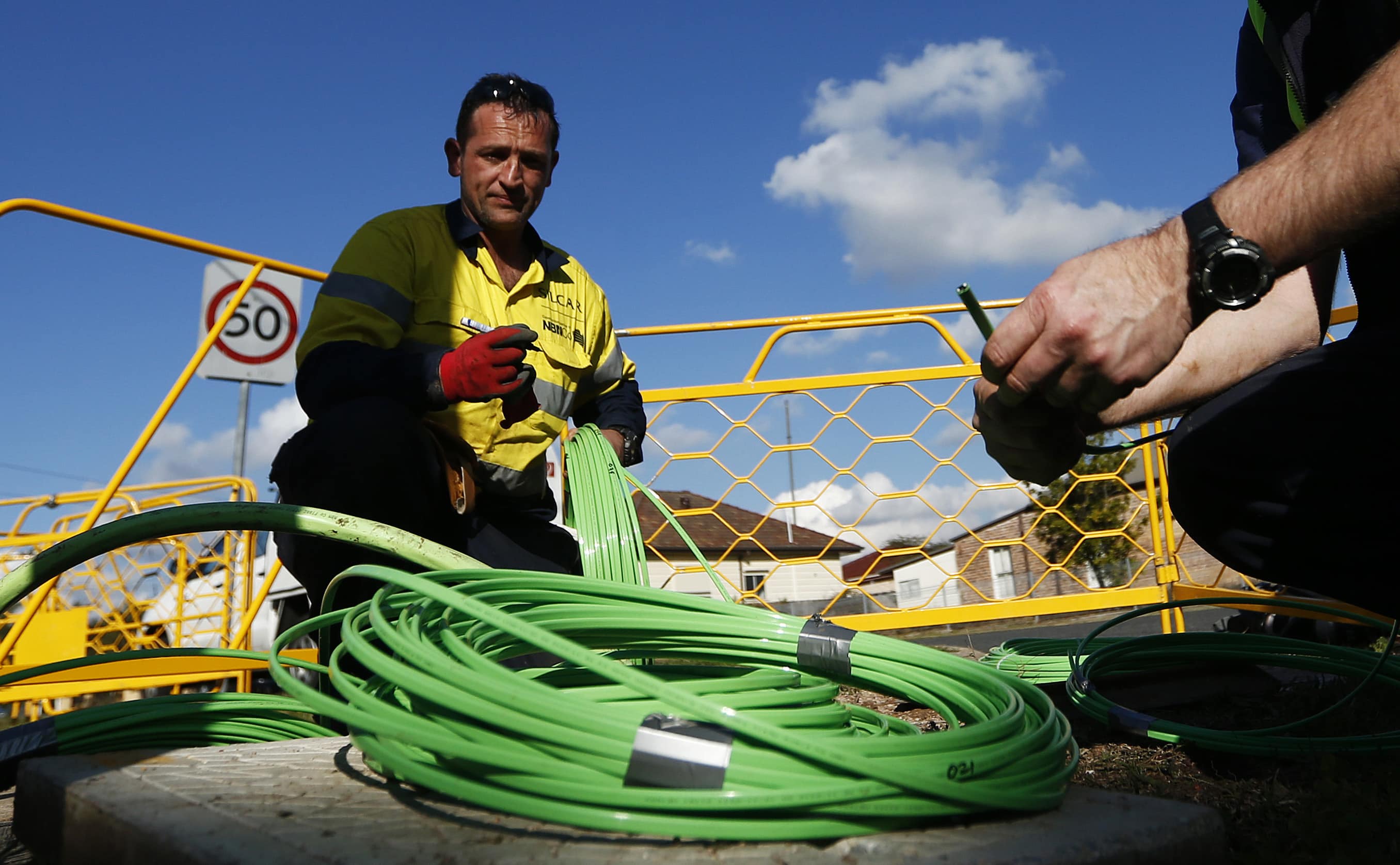 NBN Co. workers arrange fibre-optic cables used in the National Broadband Network in Sydney, 11 July 2013, REUTERS/Daniel Munoz